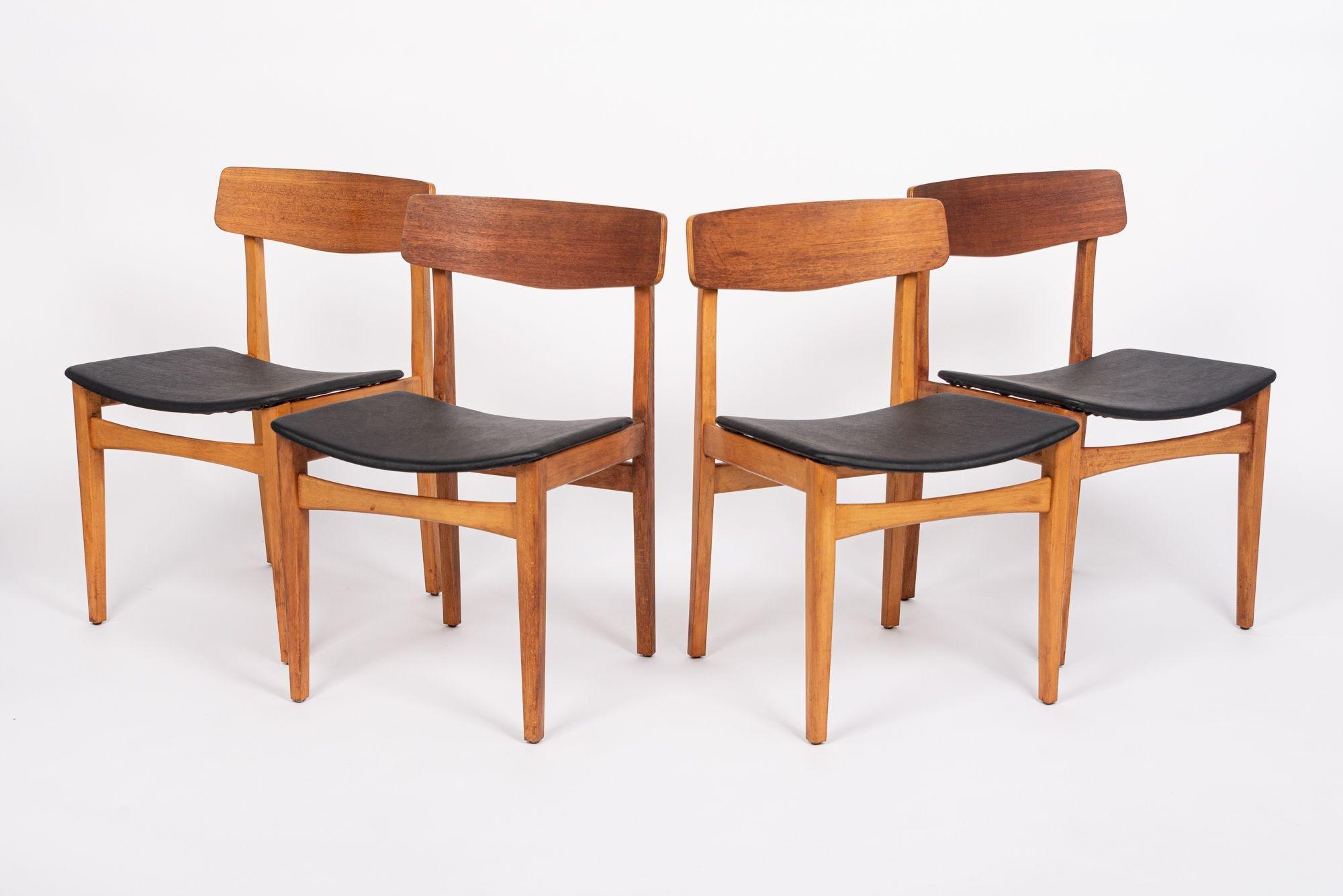 This set of four vintage mid century Danish modern teak wood dining chairs are circa 1960. These chairs have a classic Scandinavian design with clean lines and gentle curves. The chairs have a warm patina with sturdy solid teak wooden frames, bent