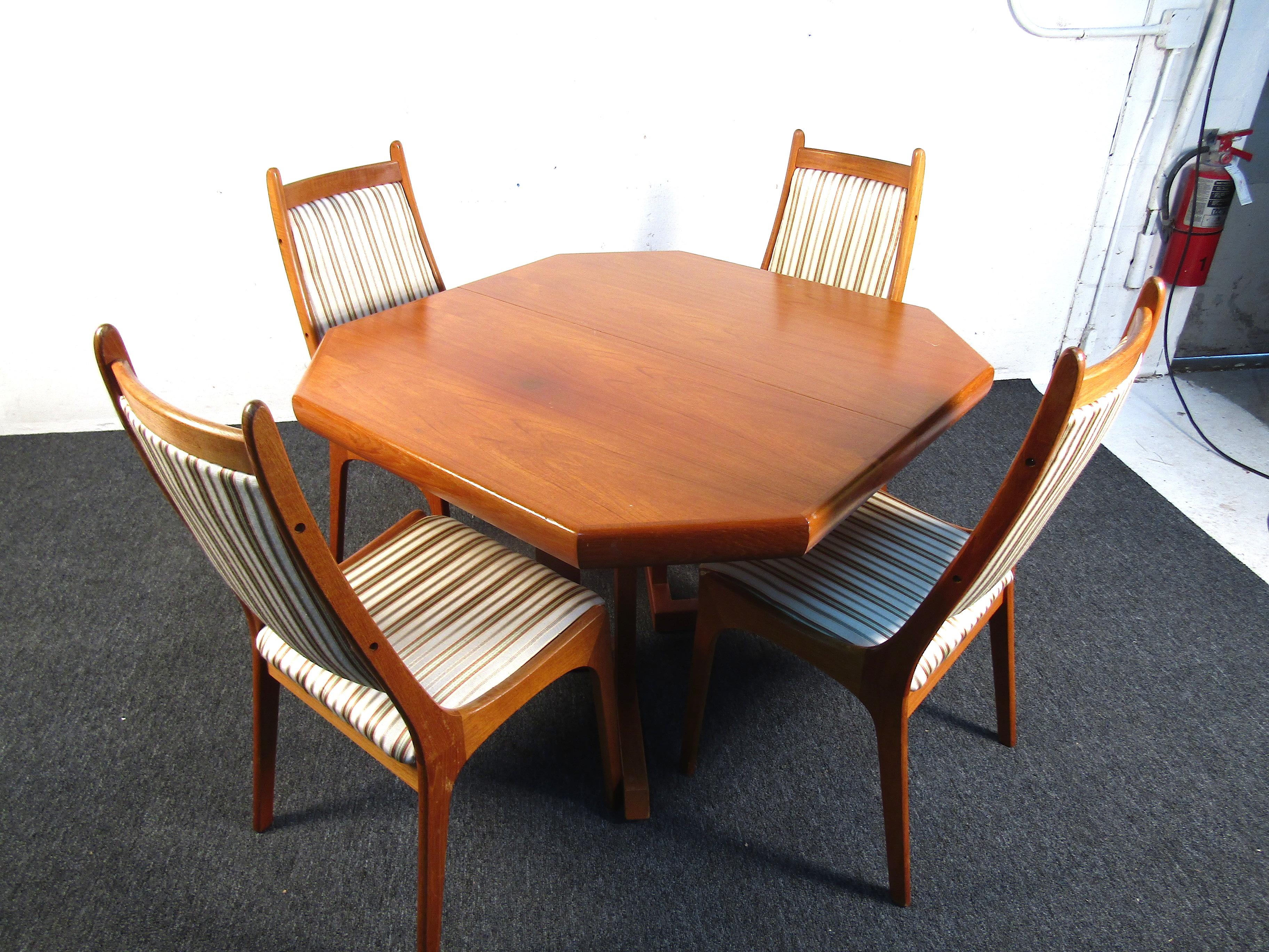 This beautiful teak wood Danish dining set features a beautifully upholstered chair and two additional leaves for when a larger table is needed. Beautiful in design with tons of functionality this set will add a presence to any home. It is able to