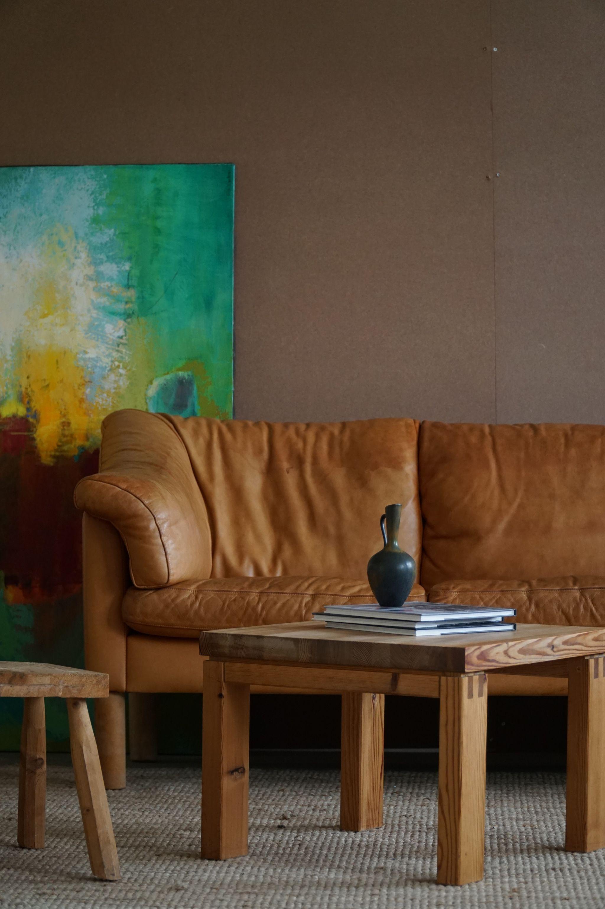 Mid century danish three seater sofa in cognac coloured leather, feets made in beech, made in 1970s.

Great modern lines and a stunning warm patina in this classic danish sofa.
    