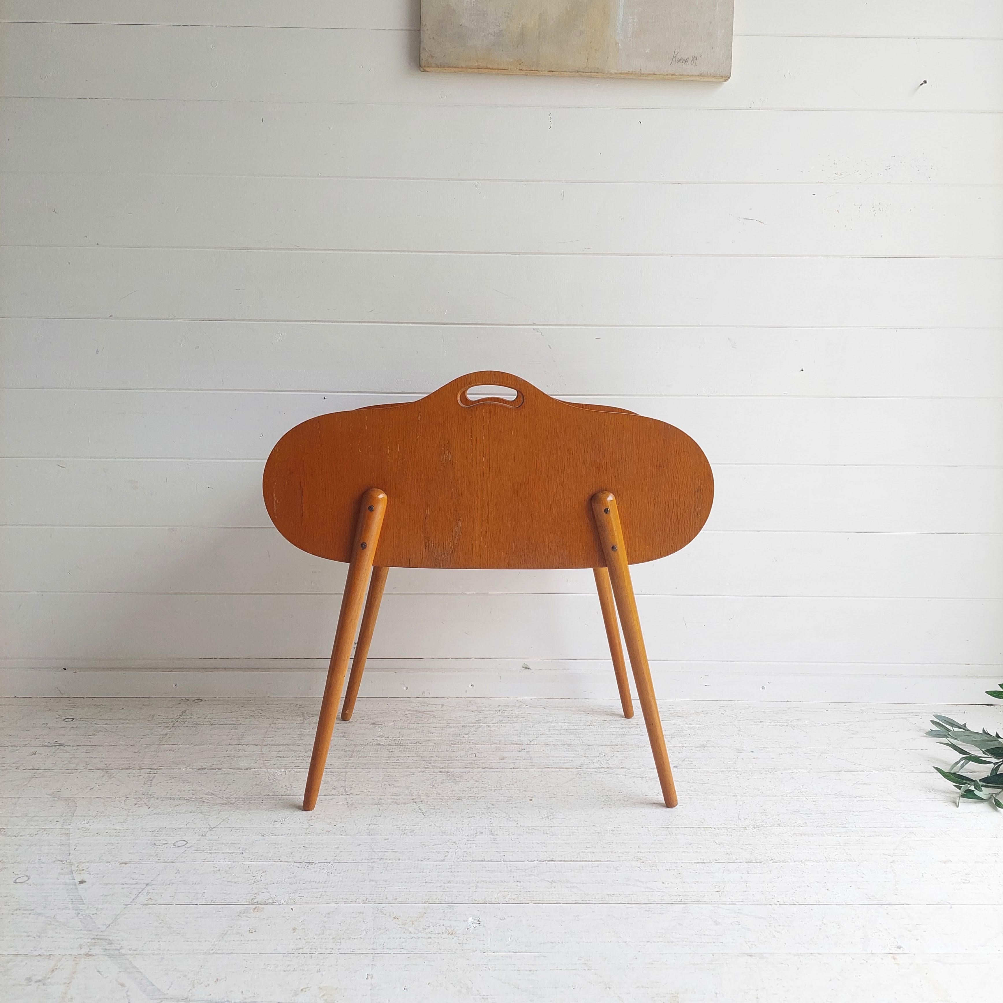 Mid-century Danish sewing box with a tambour roll top dating from the 1950/60s. 
The top rolls around the whole box-body forward and back. 

Larger than the average sewing box with mid-century Danish styling and a beautiful light wood finish. 
A