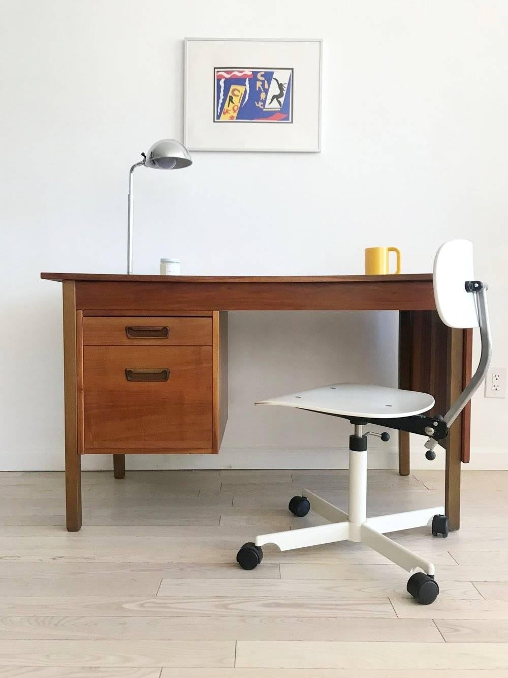 A Danish walnut beauty. Two-drawer desk with expandable writing surface in superb vintage condition. Original receipt intact, purchased in 1970s at high end furniture store, Maurice Villency. 

Measures: 46