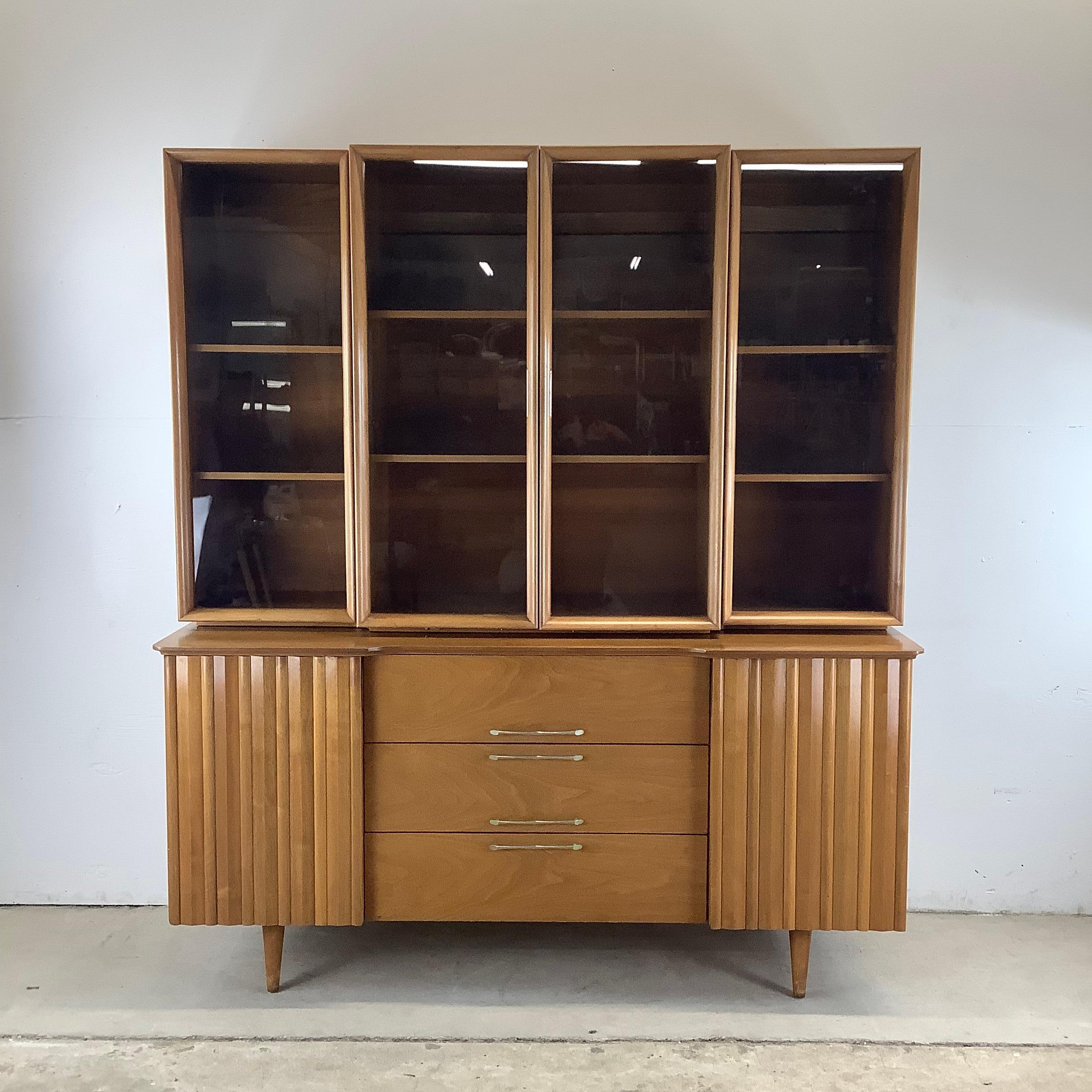 Bring timeless elegance to your home with this mid-century Danish walnut sideboard and display hutch. A masterpiece of Scandinavian design, this two-piece unit showcases the perfect combination of form and function. The warm walnut finish and clean