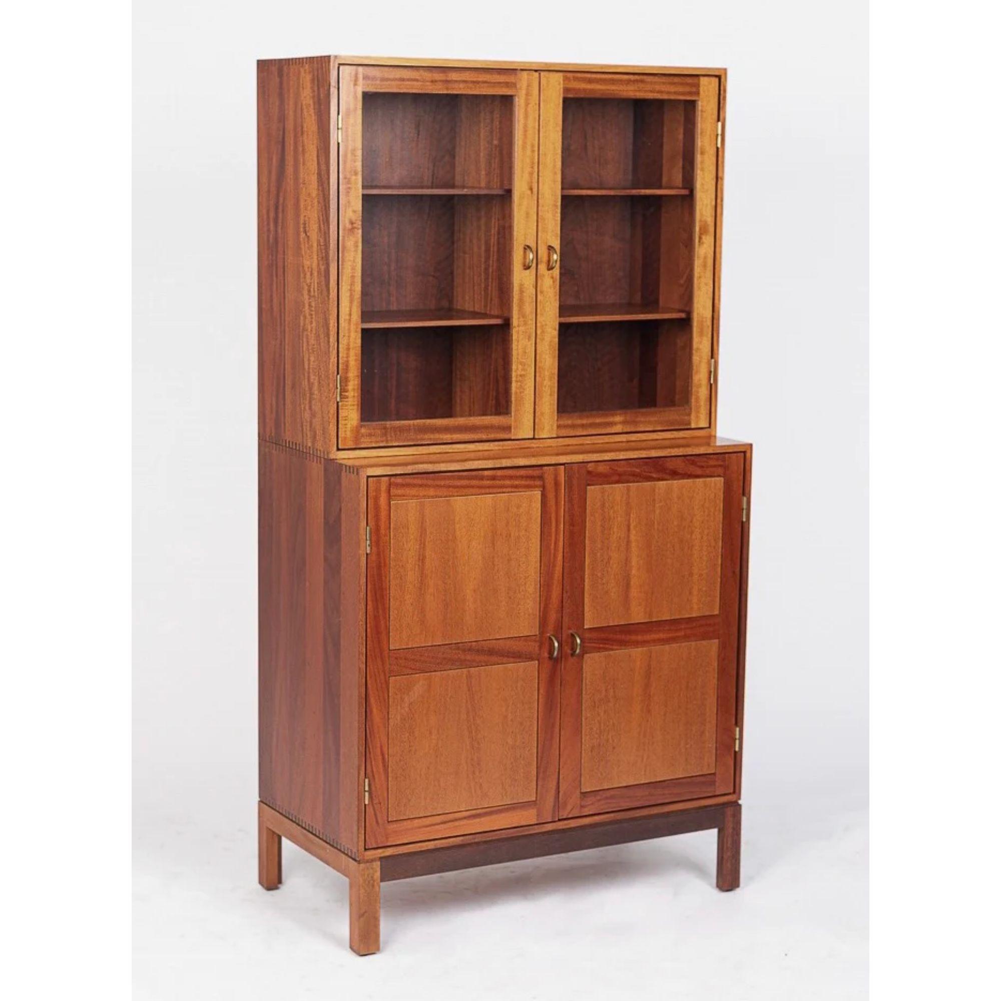 This incredible matching pair of vintage midcentury Danish modern storage cabinets was made in Denmark circa 1960. Impeccably crafted from teak wood, the cabinets feature multi-tone shades of teak with gorgeous, distinctive dovetail joinery