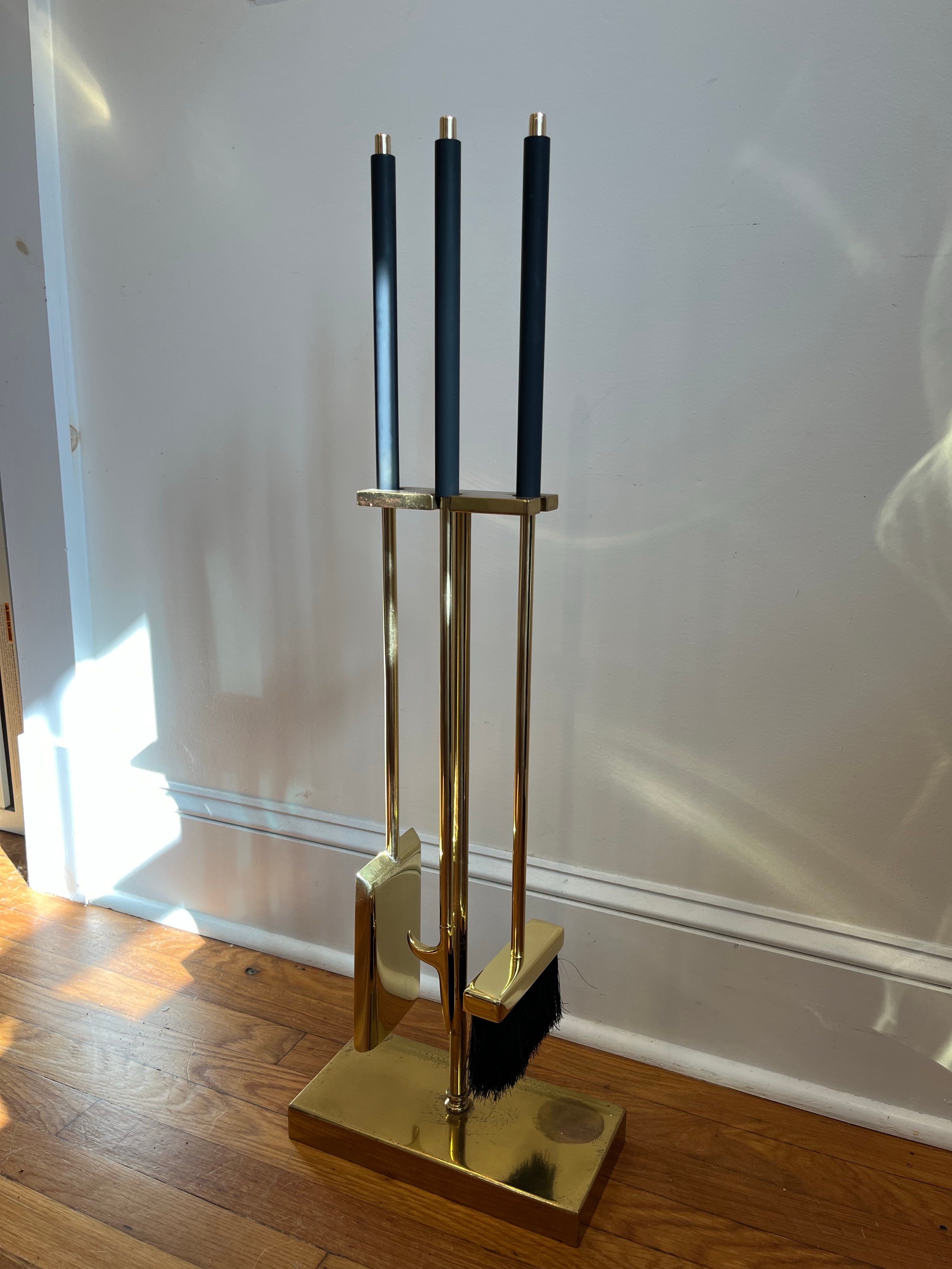 Spettacolari strumenti per caminetti di metà secolo di Danny Alessandro. Ottone con manici in smalto nero. Design pulito e classico. Il set comprende un cavalletto con fessure per contenere gli attrezzi, un attizzatoio, una spazzola e una pala.