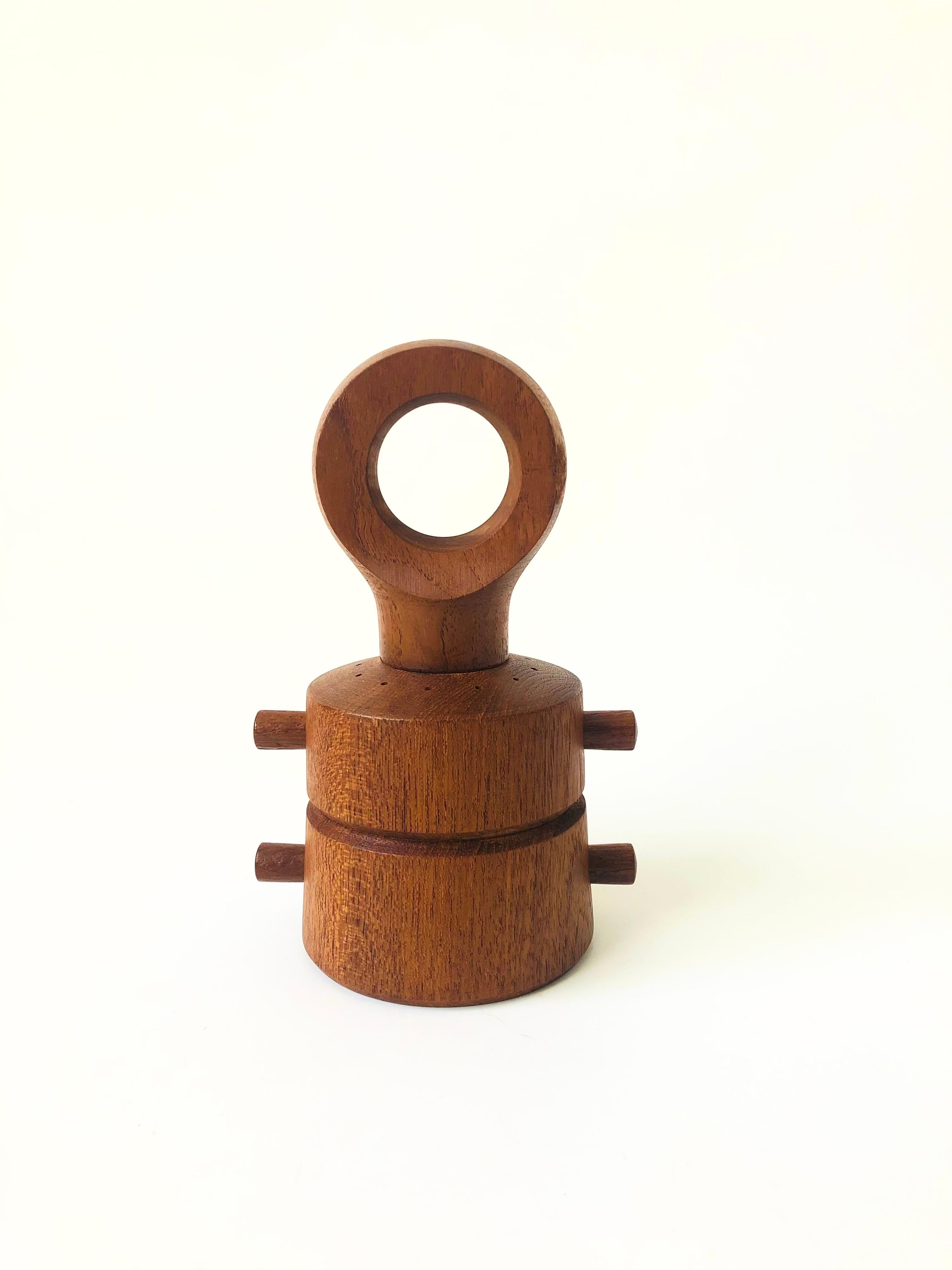 A mid century teak pepper mill and salt shaker combo designed by Jens Quistgaard for Dansk. Beautifully designed, 