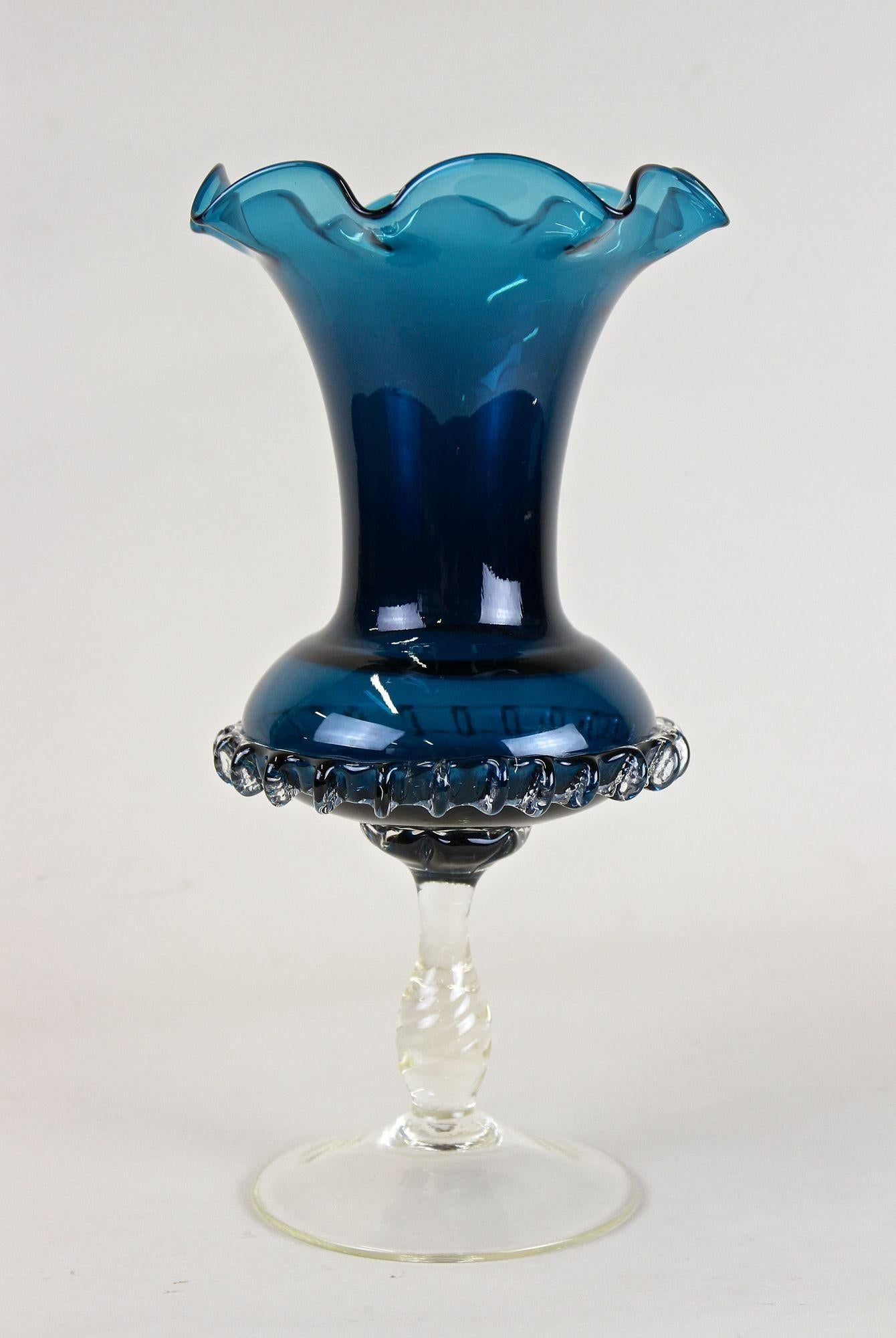 Delicate blue Murano glass vase from the midcentury period around 1960 in Italy. This elegantly shaped vintage glass vase is a perfect example for the world famous Italian glass art from the small island of Murano. The extraordinary design with