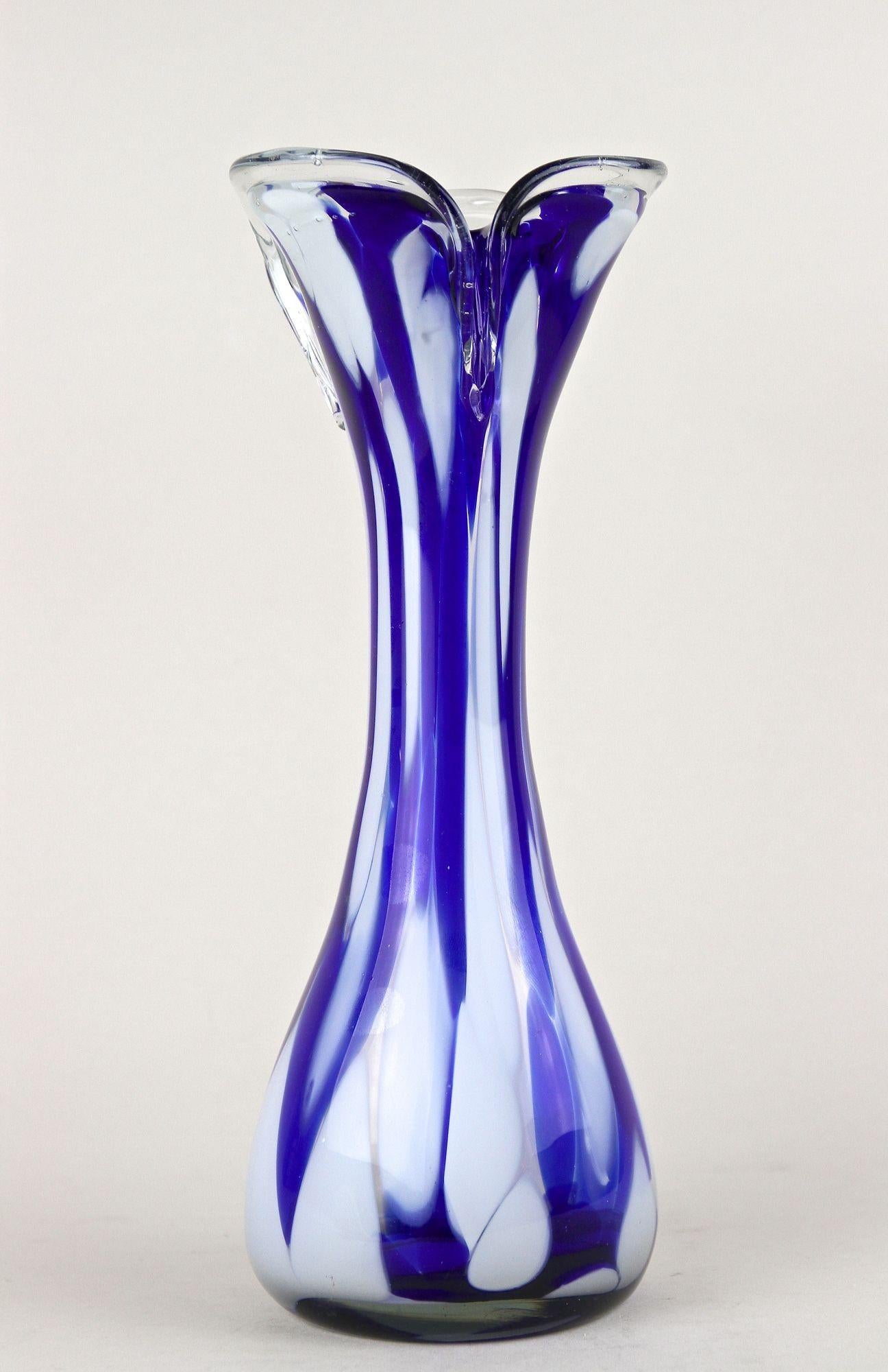 Vaso in vetro blu/bianco molto decorativo della fine del secolo scorso, proveniente dai famosi laboratori dell'isola di Murano, in Venezia/Italia. Elaborato a mano nel periodo intorno al 1970, questo grazioso vaso in vetro italiano colpisce per il