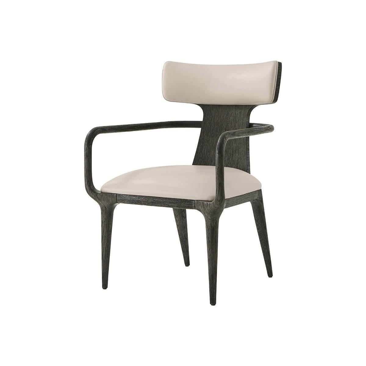 The upholstered dining arm chair features a subtle Scandinavian design with a twist on the traditional high-backed design, which makes it unique to your home. Its clean naturally tapered lines of the legs support a plush medium firm density