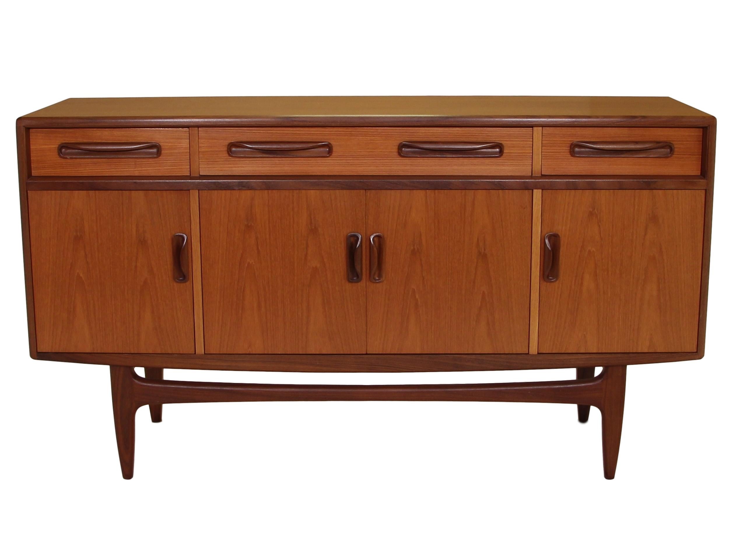 Outstanding small teak credenza. It was designed in the 1960s by Victor Bramwell Wilkins for G Plan's Fresco Range. It has original light blue fabric which is in good condition.

Style: Danish modern.

It is in very good condition. There are