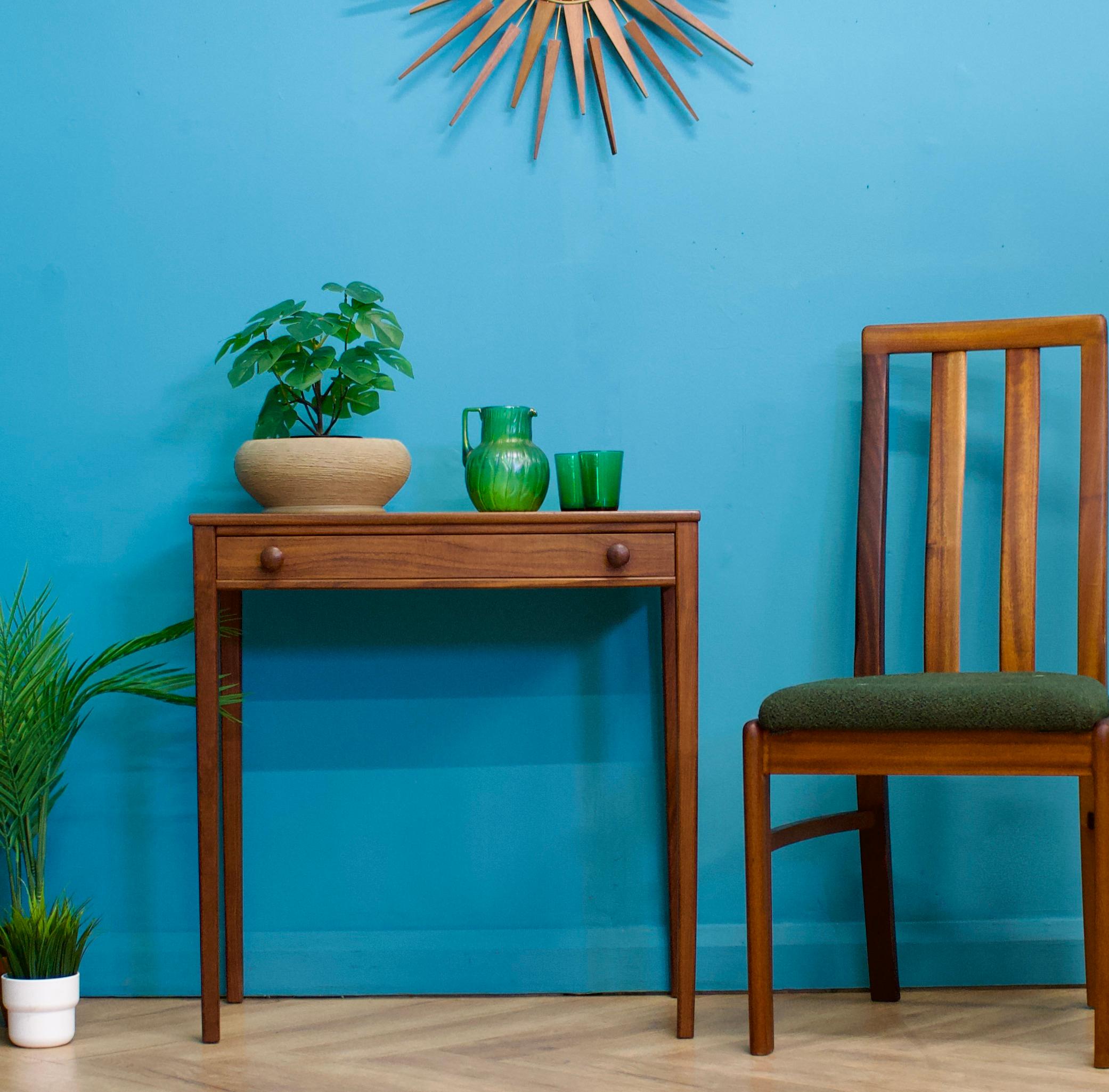 A dark teak console /  hall table from Younger - circa 1960s
This could be used as a compact dressing table
Featuring solid teak, long delicate tapered legs and a drawer with solid teak handles
