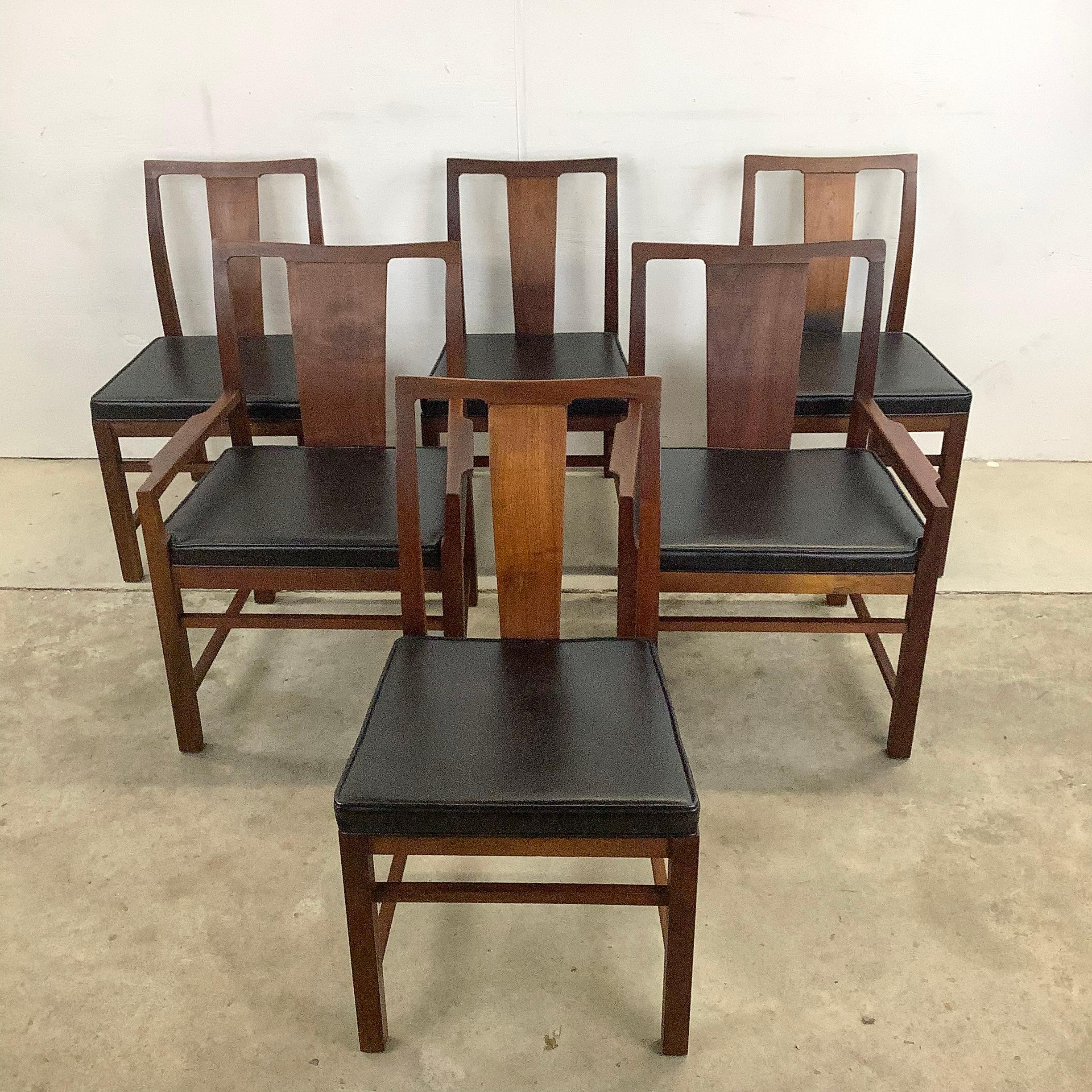 This sturdy and stylish set of six mid-century modern dining chairs from Hibriten manufacturing make a comfortable mcm style addition to any dining set. The dark walnut finish is wonderfully complimented by wide black naugahyde style seats, with