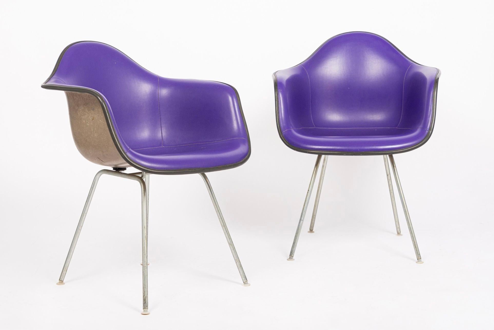 These vintage mid century modern DAX bucket purple lounge chairs were designed by Charles and Ray Eames for Herman Miller. The iconic DAX chair - Dining (D) Arm Chair (A) on X Base (X) - was designed by the Eameses for Herman Miller in the 1950s and