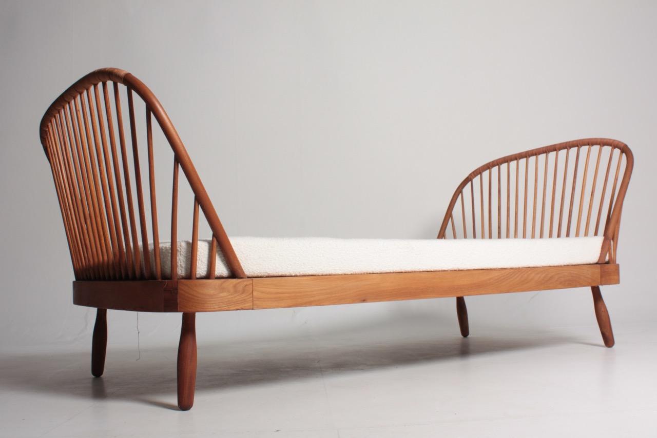 Great looking daybed in solid elm, designed by Maa. Frode Holm for Illums Bolighus in the 1940s. Made in Denmark by H&F Tremmeværk cabinetmakers. Great original condition.