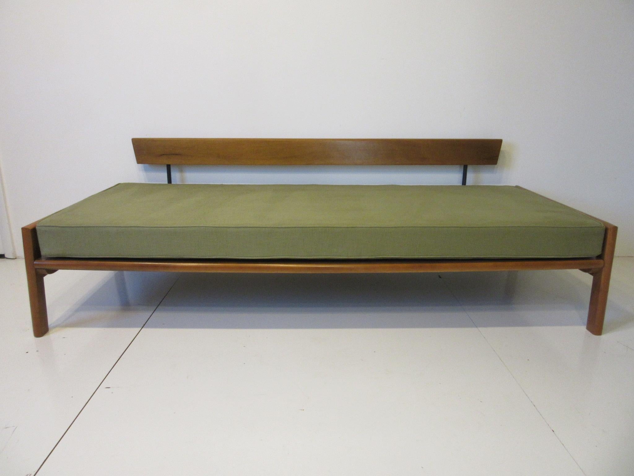 A well constructed solid maple sofa / daybed with framed sides to hold the bottom cushion and back support to the rear cushions so it can be placed any where in a room or used as a spare bed for guests. Reupholstered in a celery green woven soft