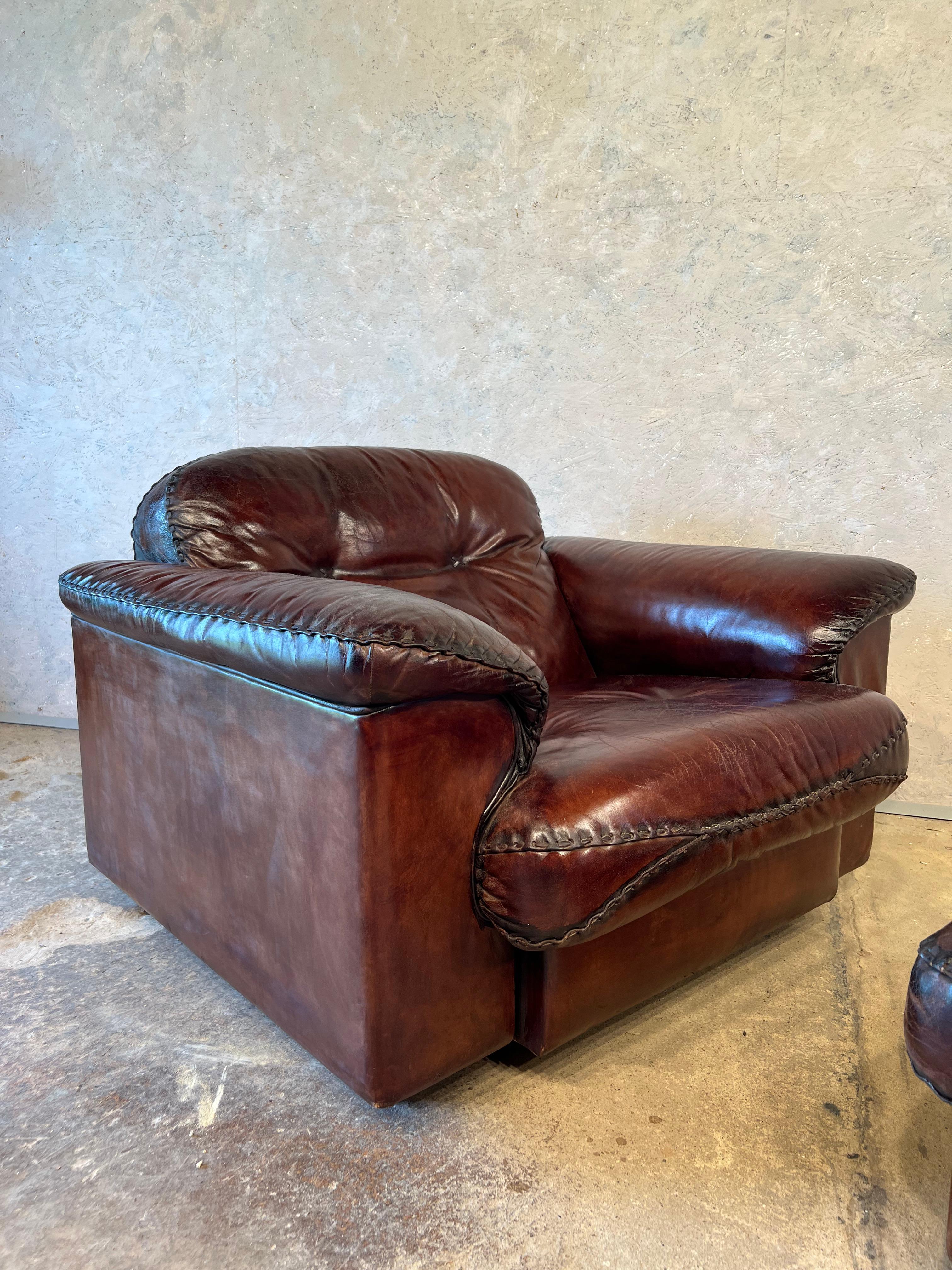 Super fine mid century De Sede DS 101 Lounge Armchair and Foot stall . Switzerland 1970, these lusciously oversized armchairs have extendable seats for extra comfort, upholstered in the finest thick Cuban brown neck leather with braided leather