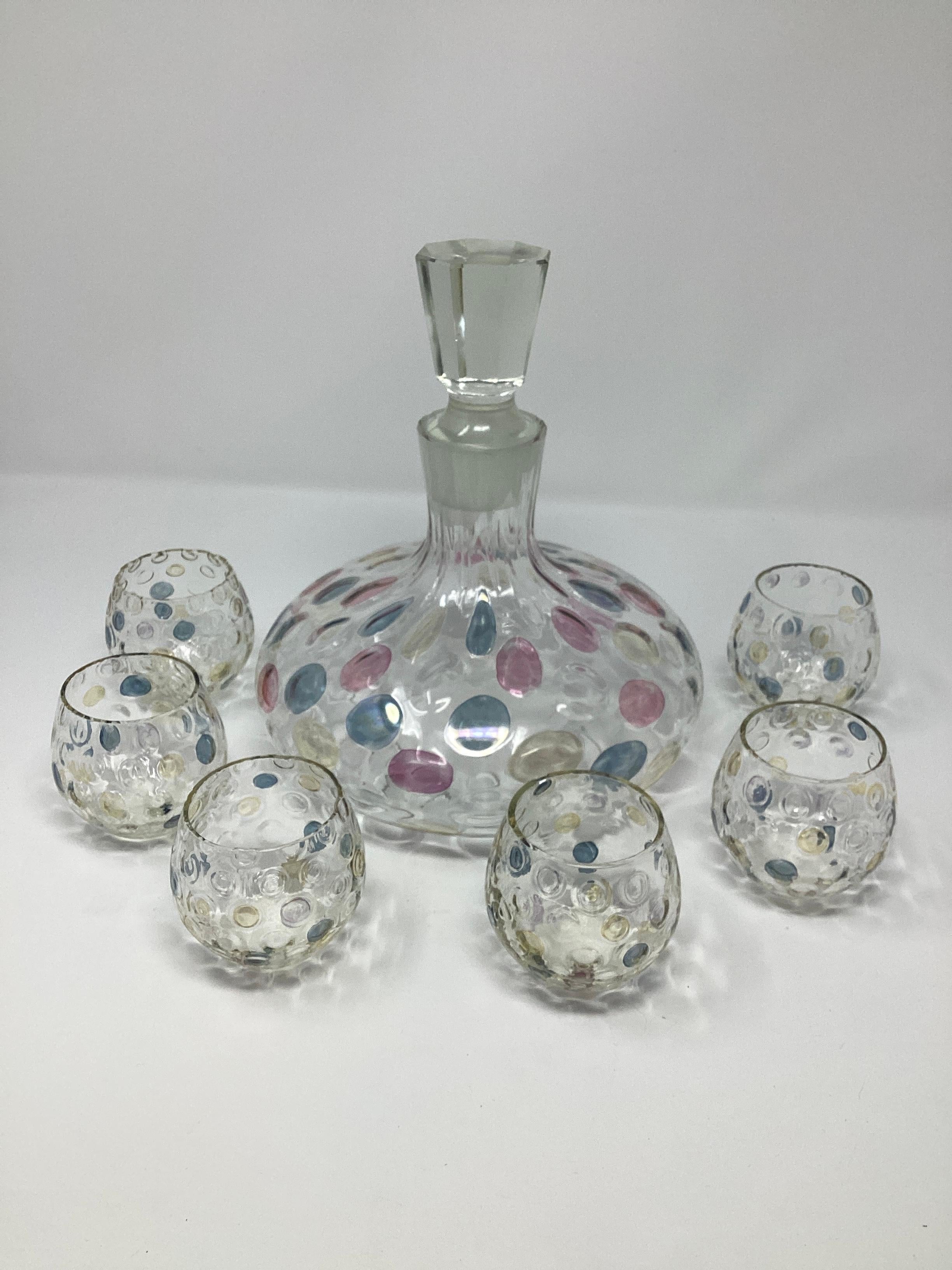 Mid Century Decanter Set consisting of a decanter and 6 small roll poly glasses.
