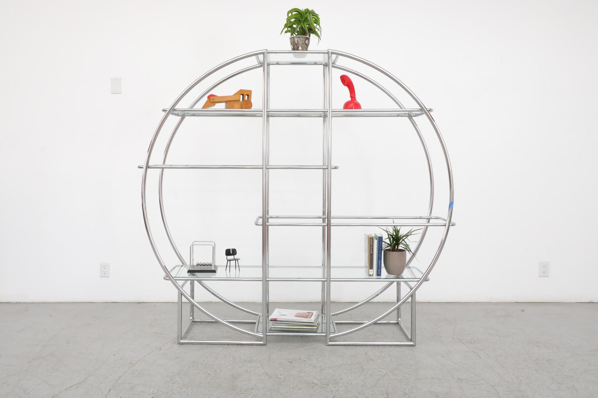 Gorgeous, Deco style, round chrome and glass étagère unit with 6 glass shelves. Stylish as well as versatile, this piece can also double as an open and airy room divider. It is in original condition with some wear and scratches to frame and