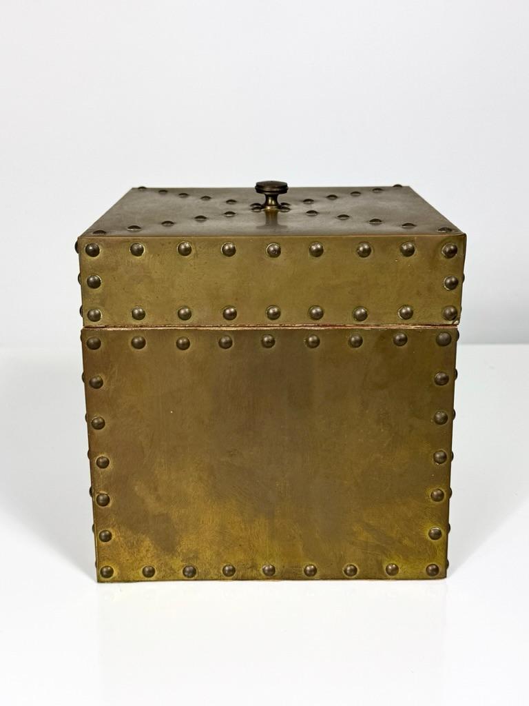 Decorative lidded box by Sarried Ltd Spain circa 1960s
Solid wood construction clad in patinated brass with nailhead trim
Lined interior with original label

7 x 7 inches wide
6.75 inch height