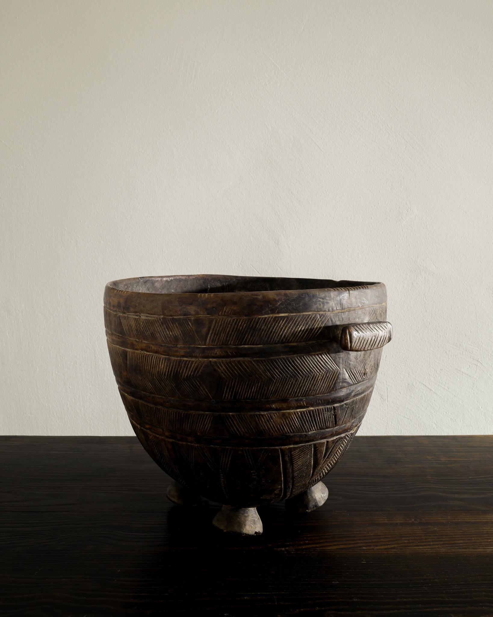 Rare and decorative wooden tribal bucket in solid wood produced in Africa around 1950s. Very nice hand made / carved details. 

Dimensions: H: 11 in (28 cm) Diameter: 13.40 in (34 cm)
