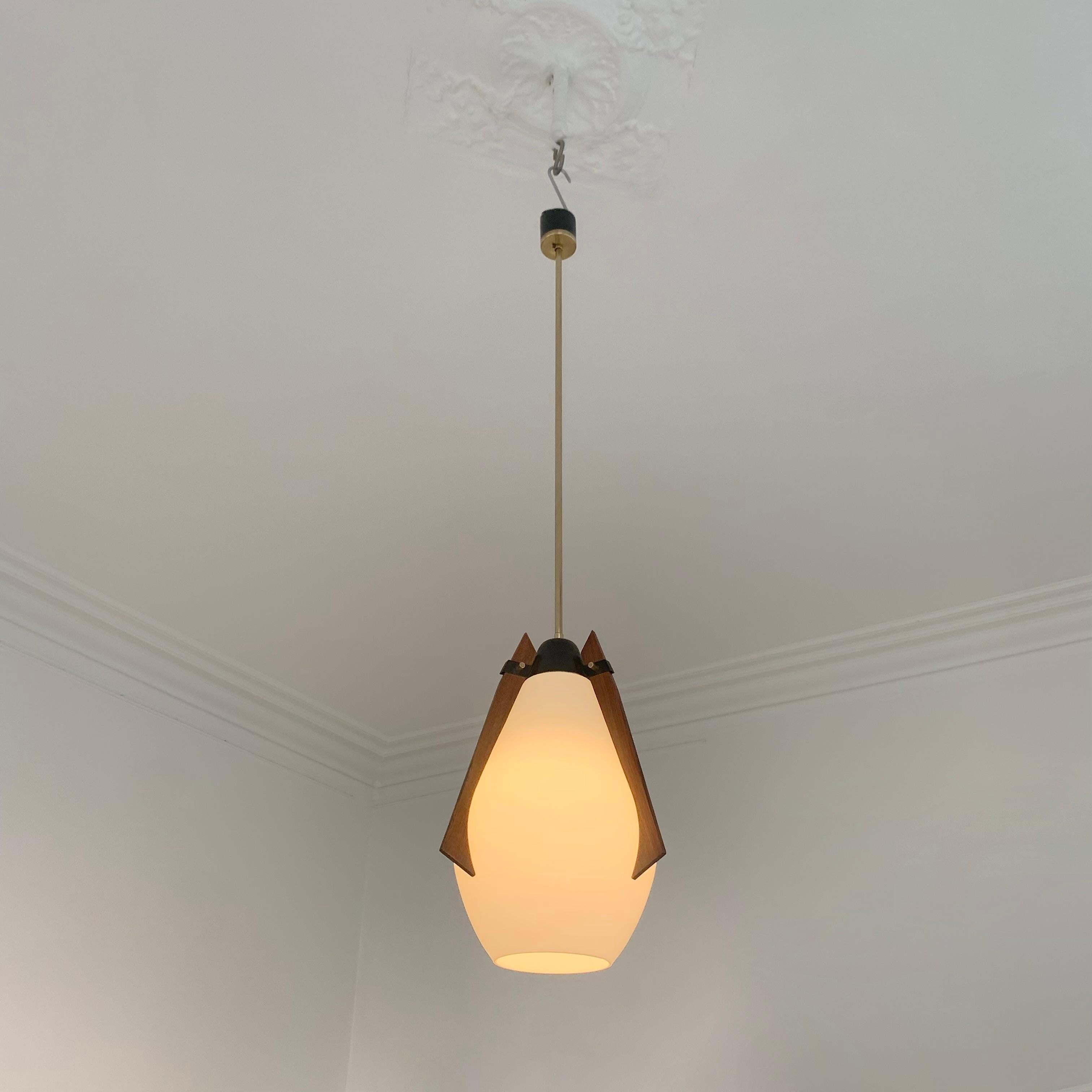 Mid-century decorative hanging lamp, circa 1960, Italy.
Teak, opaline glass and brass details.
Total height with brass stem: 110 cm, height without the stem: 38 cm. 
Diameter: 25 cm .
Rewired, one E27 bulb.
Good original condition.
All purchases are