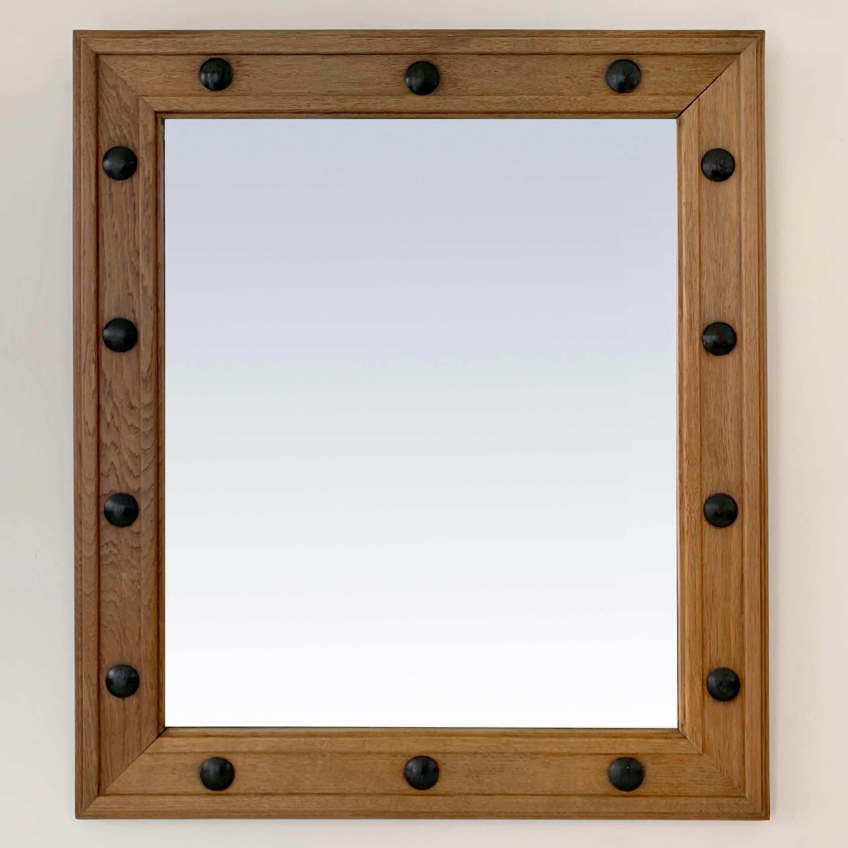 Very beautiful vintage mirror, circa 1950, France.
Solid oak and black metal decorative cabochons, beveled mirror.
Dimensions: 80 cm H, 70 cm W, 3 cm D.
Original condition, also the beveled mirror glass.
Rare model on the market.
All purchases are