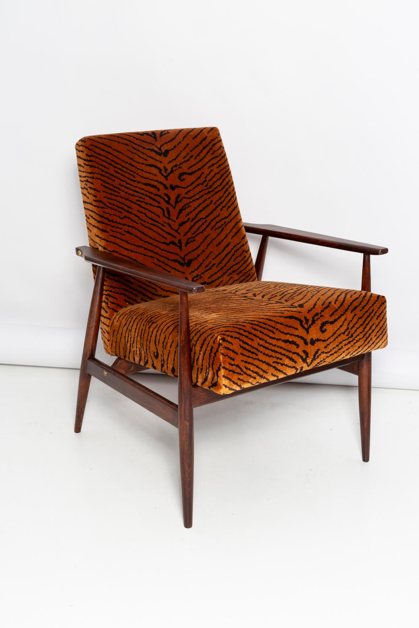 A beautiful, restored armchair designed by Henryk Lis. Furniture after full carpentry and upholstery renovation. The fabric, which is covered with a backrest and a seat, is a high-quality Italian Dedar velvet upholstery printed in tiger pattern. The