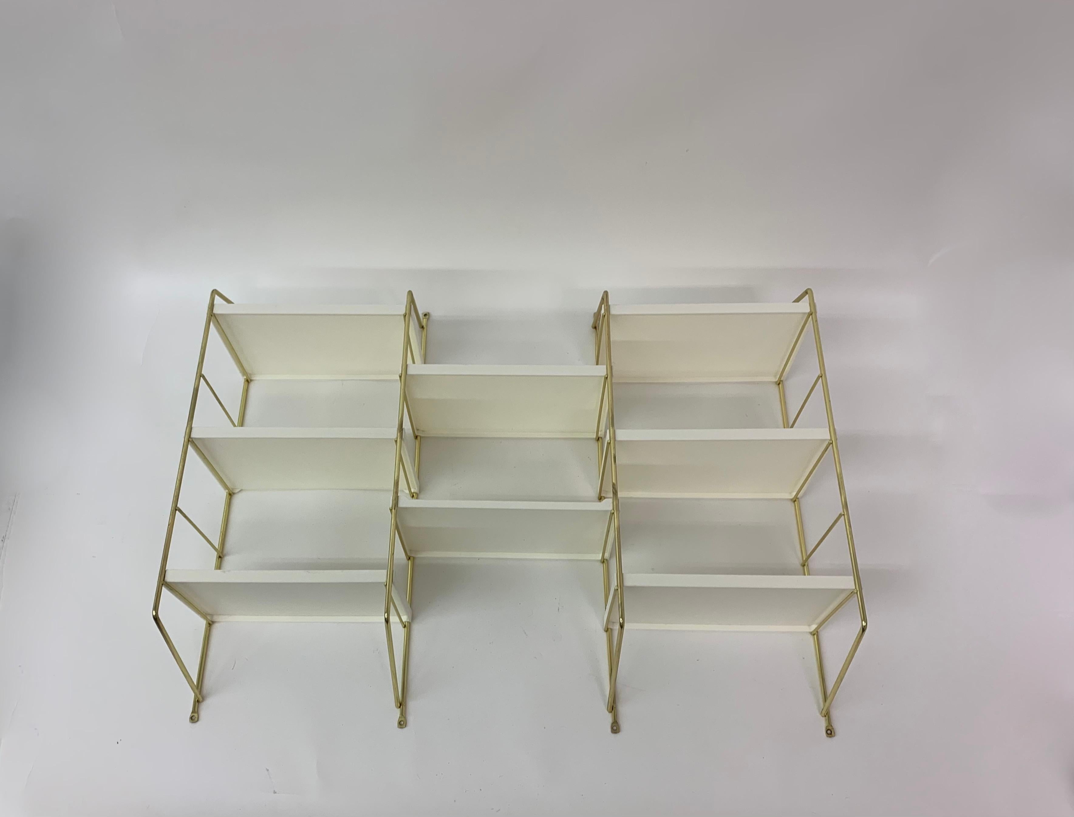 Metal holders with plastic shelves.