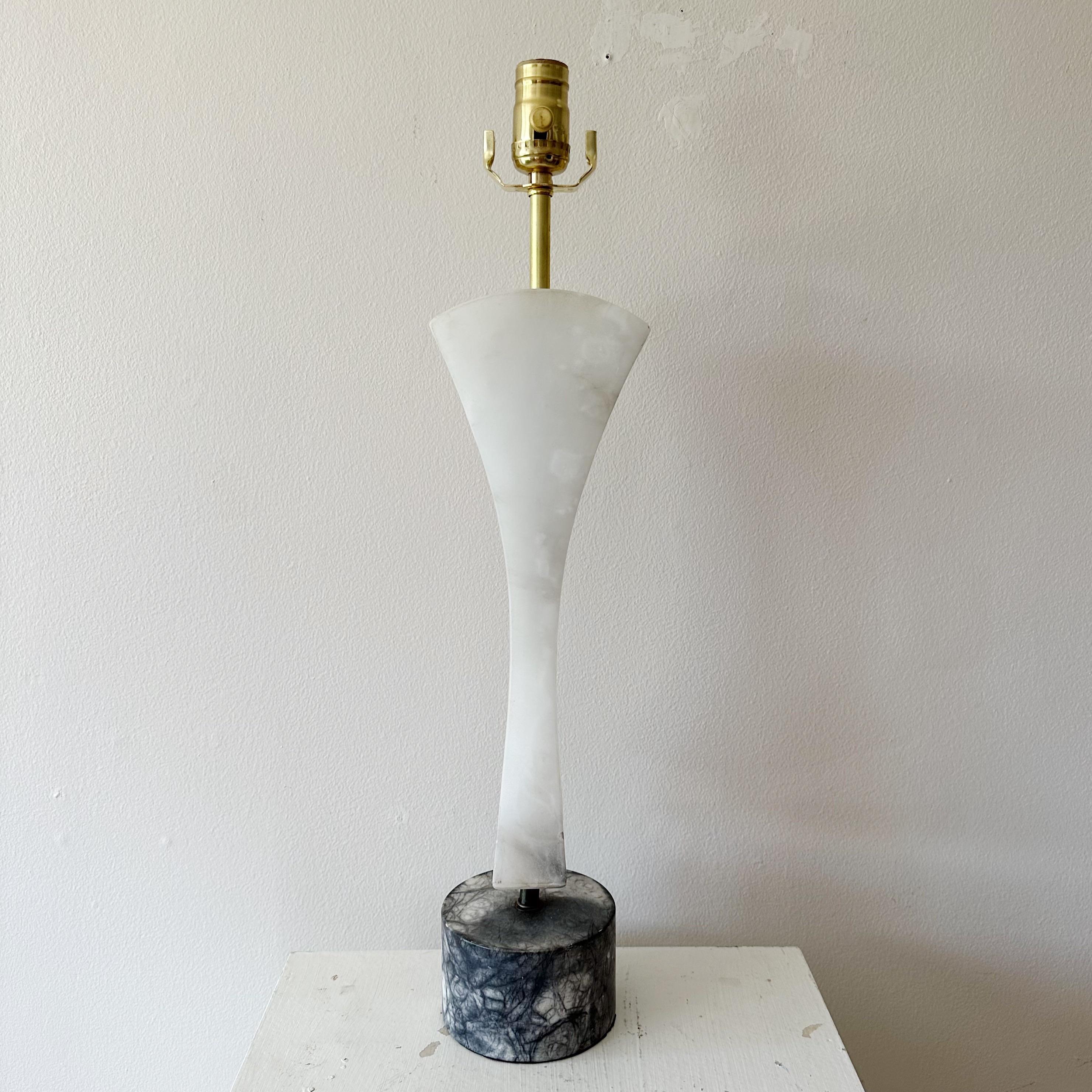 Sculptural mid 20th century alabaster table lamp from the 1950s. A great sculptural design with the centerpiece being in white alabaster and the base in black and white alabaster. Probably Italian. Professionally rewired with new fittings and a