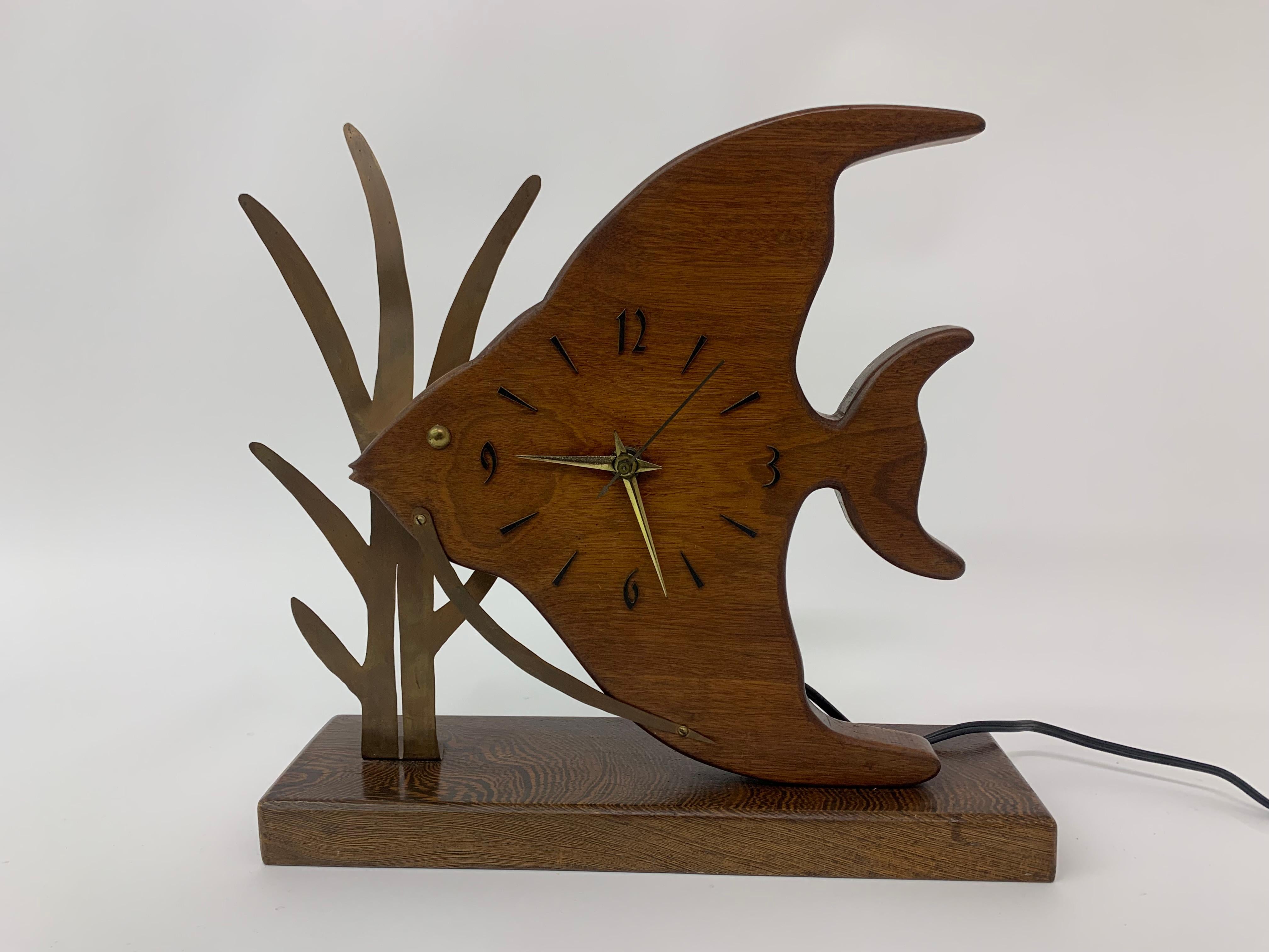 Mid-century design Teak wooden Fish Nufa clock , 1960’s

Dimensions: 31cm H, 33cm W, 9,5cm D
Period: 1960’s
Material: Wood, Metal
Condition: In good working condition