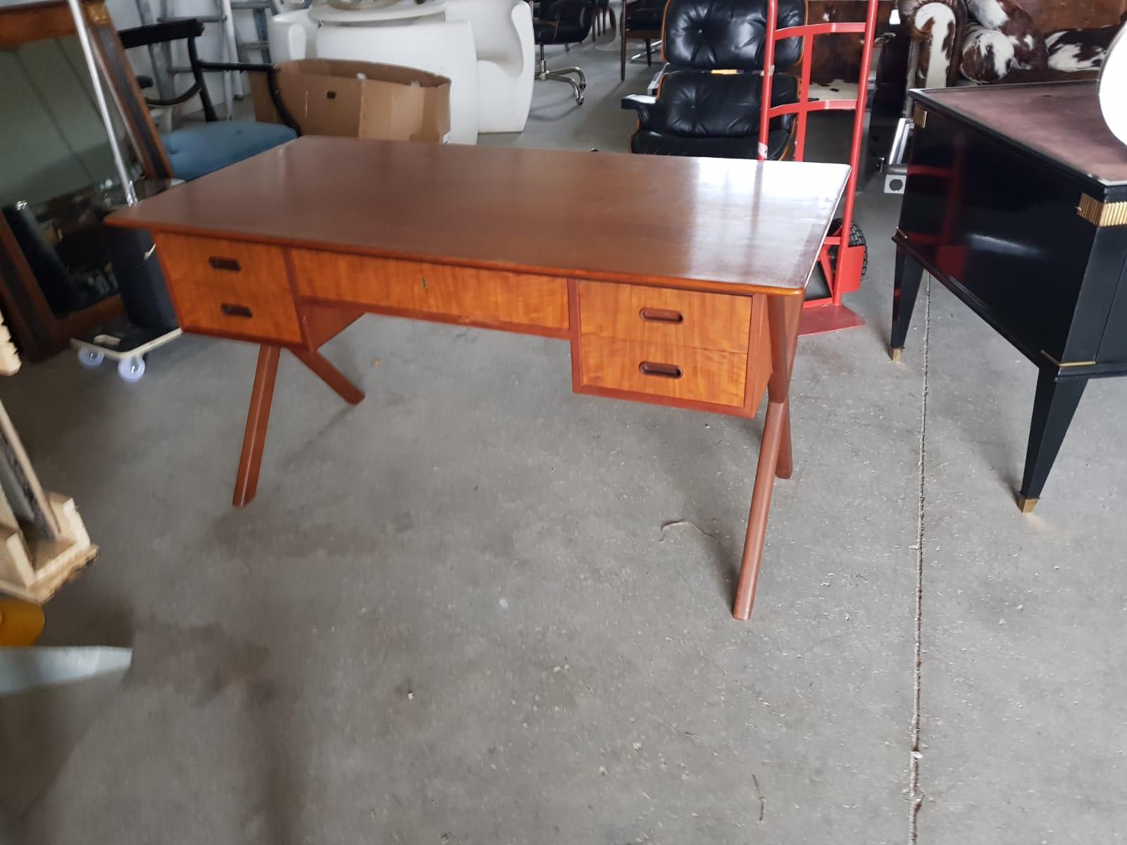 Mid century design teak wood desk with four drawers
Size: H 75 cm, W 140 cm, D 75 cm.
Good condition. Conservative restoration. Wears coherent with age and prior gentle use. 
A video is available upon request.