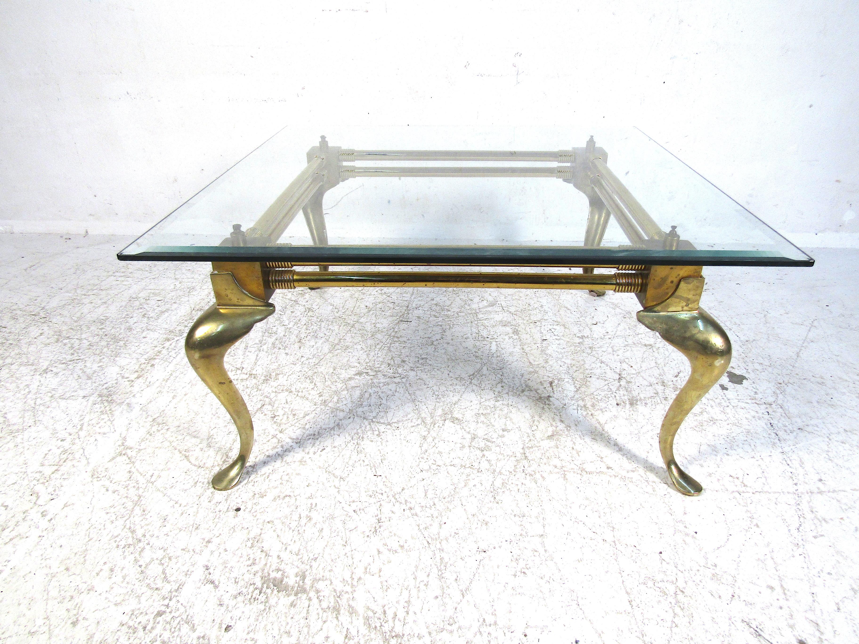 This beautiful coffee table features a bold brass base with an elegant glass top. Simple in design this table will perfectly accent your home in any room it is placed in. Please confirm the item location with the dealer. (NJ/NY).