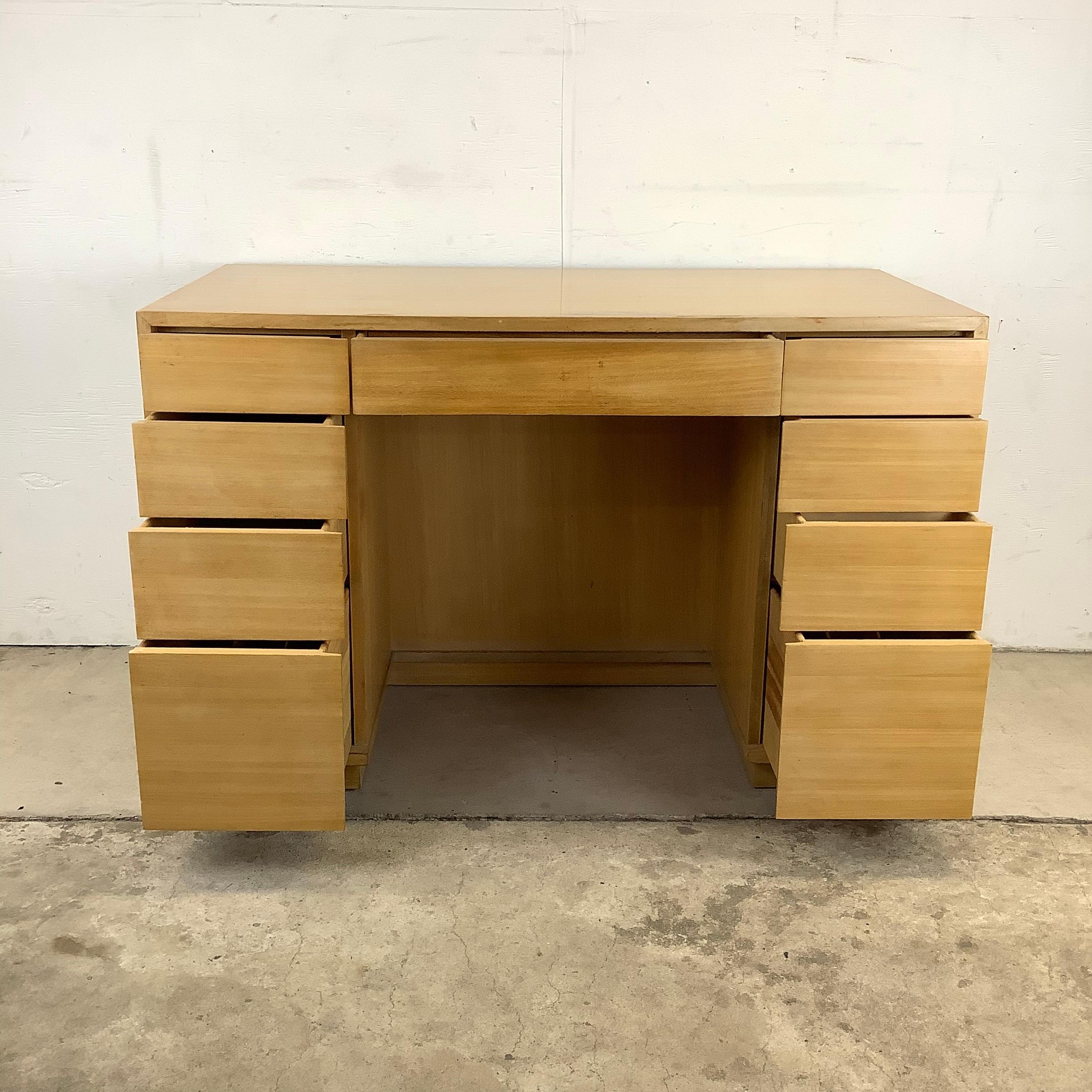 This striking double-sided desk from the Drexel Precedent line by Edward Wormley includes a spacious array of nine drawers with plenty of storage options for any office. While the clean modern lines and vintage blonde tone wood finish makes this a