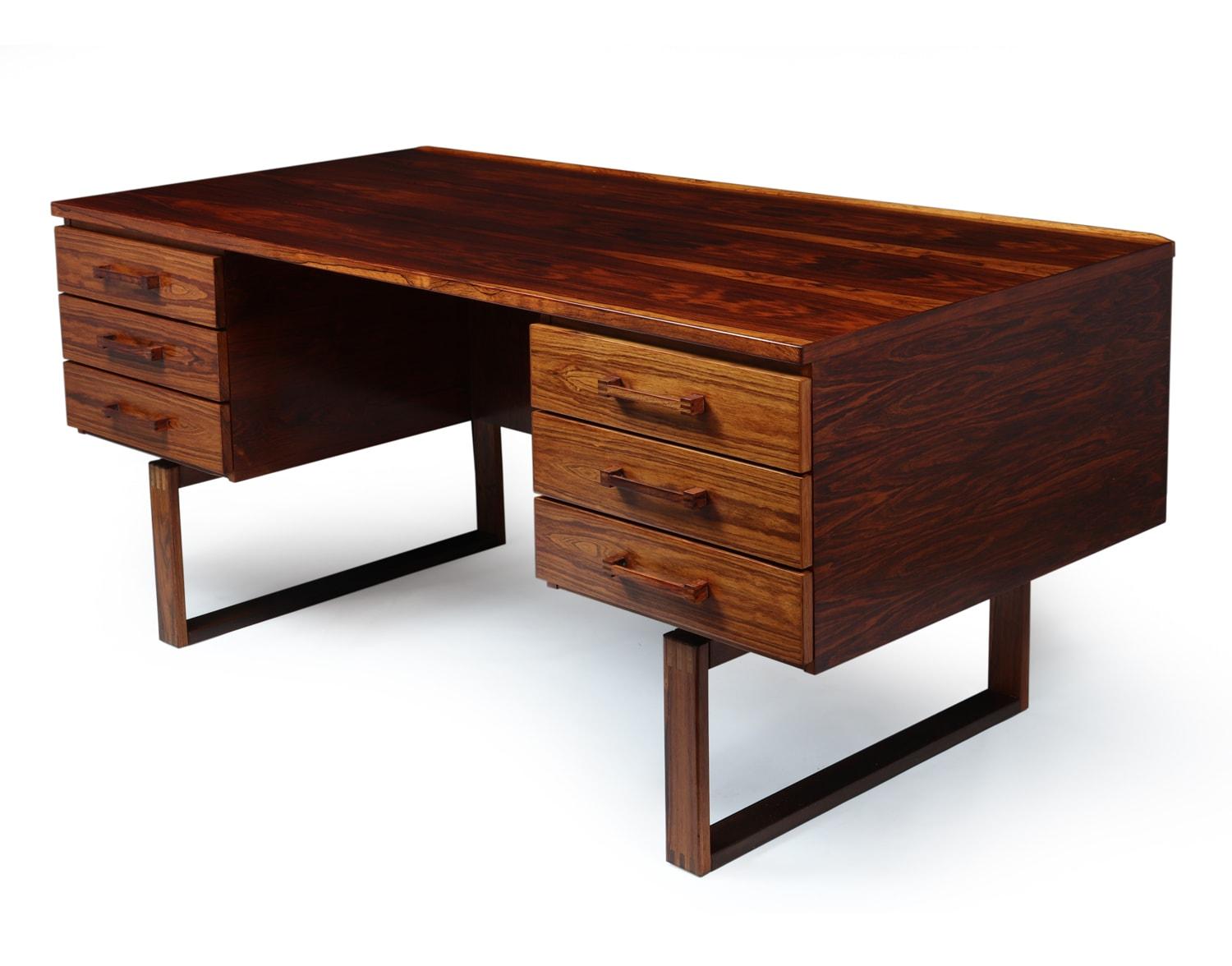 Midcentury desk by Henning Jensen
Designed by Henning Jensen and Torbin Valeur in Denmark in the mid-1960s. This rosewood desk has beautiful graining and the exposed finger joint construction. Highlighted by a subtle raised lip along the back edge,