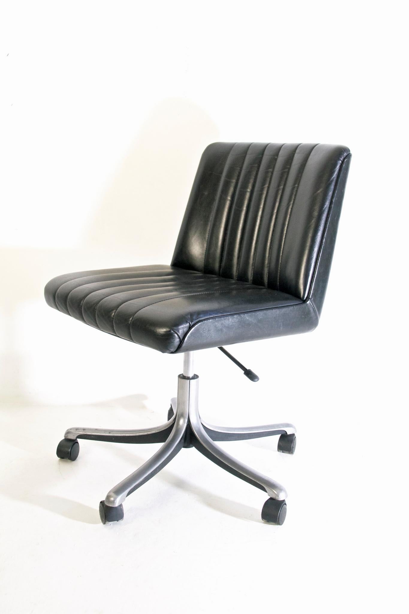 Desk chair designed by Osvaldo Borsani and manufactured by Tecno, Italy 1966-1976. This chair is from the P125 series which were produced in different editions. This particular chair has a five star wheel base and the padded upholstery in black