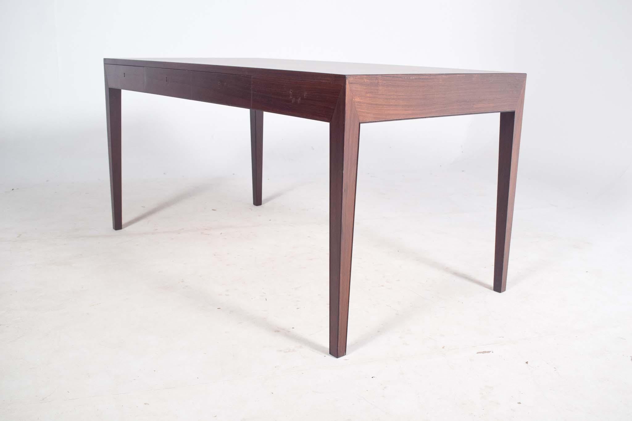 Model 36, designed by Severin Hansen in 1958 and produced by the esteemed Danish manufacturer Haslev, is one of the most exquisite desks to emerge from the Danish Modern period. Crafted in luxurious rosewood, the desk exemplifies the timeless