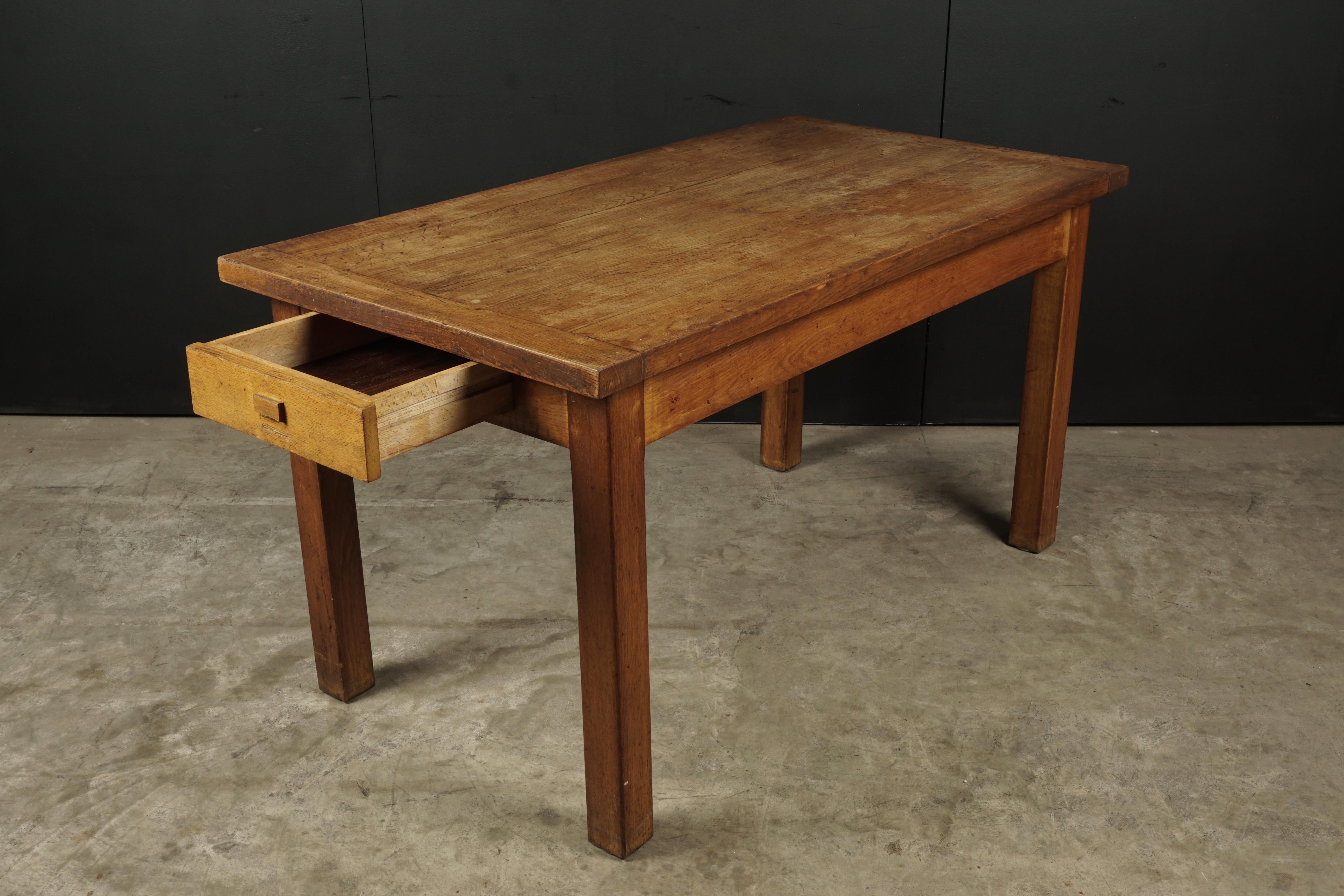 Midcentury desk from France, circa 1950. Solid pine construction with one drawer. Great patina and wear.