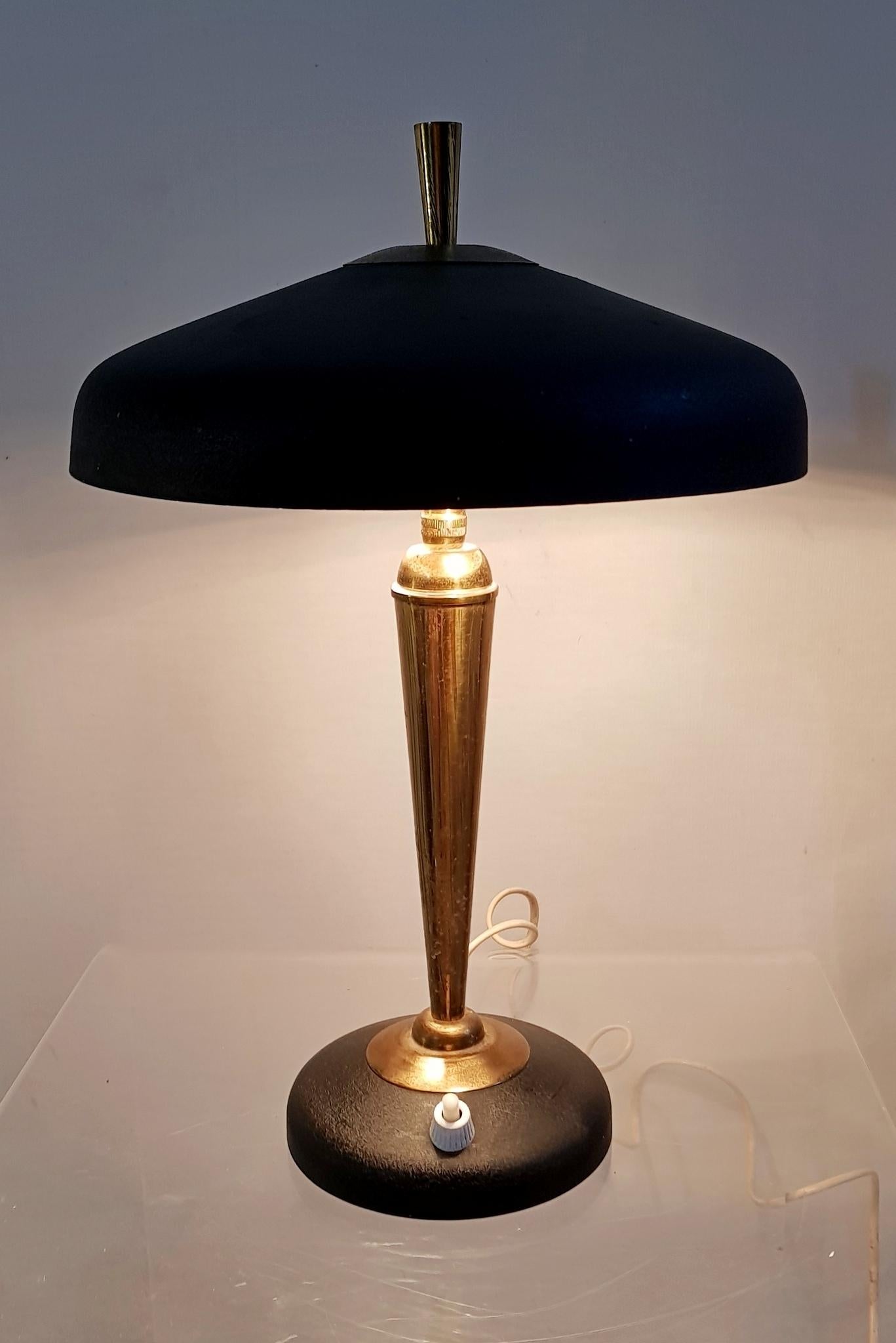 Table/desk lamp in powder coated black aluminium and brass. With flexible top with room for two light bulbs. European plug. Can be rewired for USA for an extra $25.