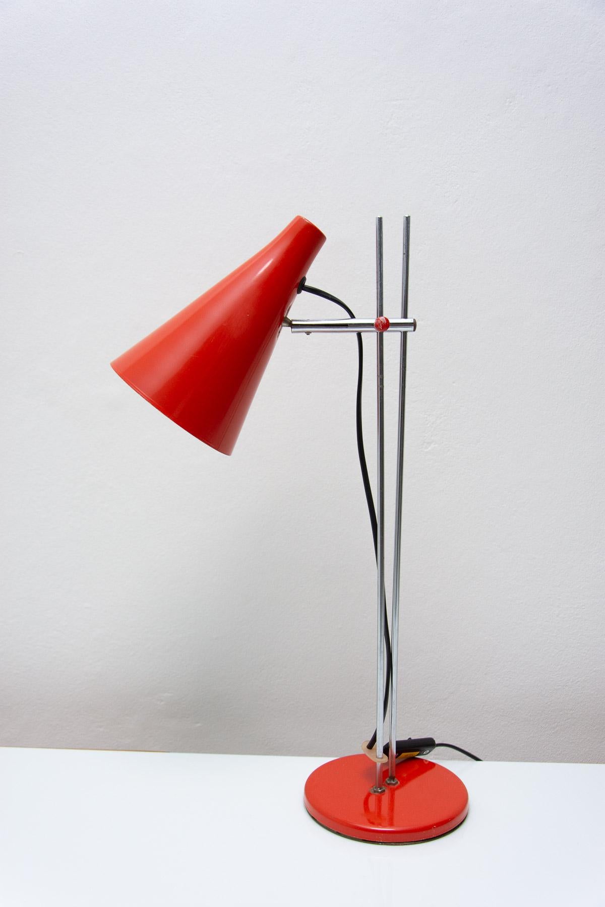 This midcentury table lamp was designed by Josef Hurka for Napako. It features a chrome arched construction to which a red cone-shaped shade is attached. Other Material: aluminum, plastic. Fully functional, newly wired, the lamp is in very good