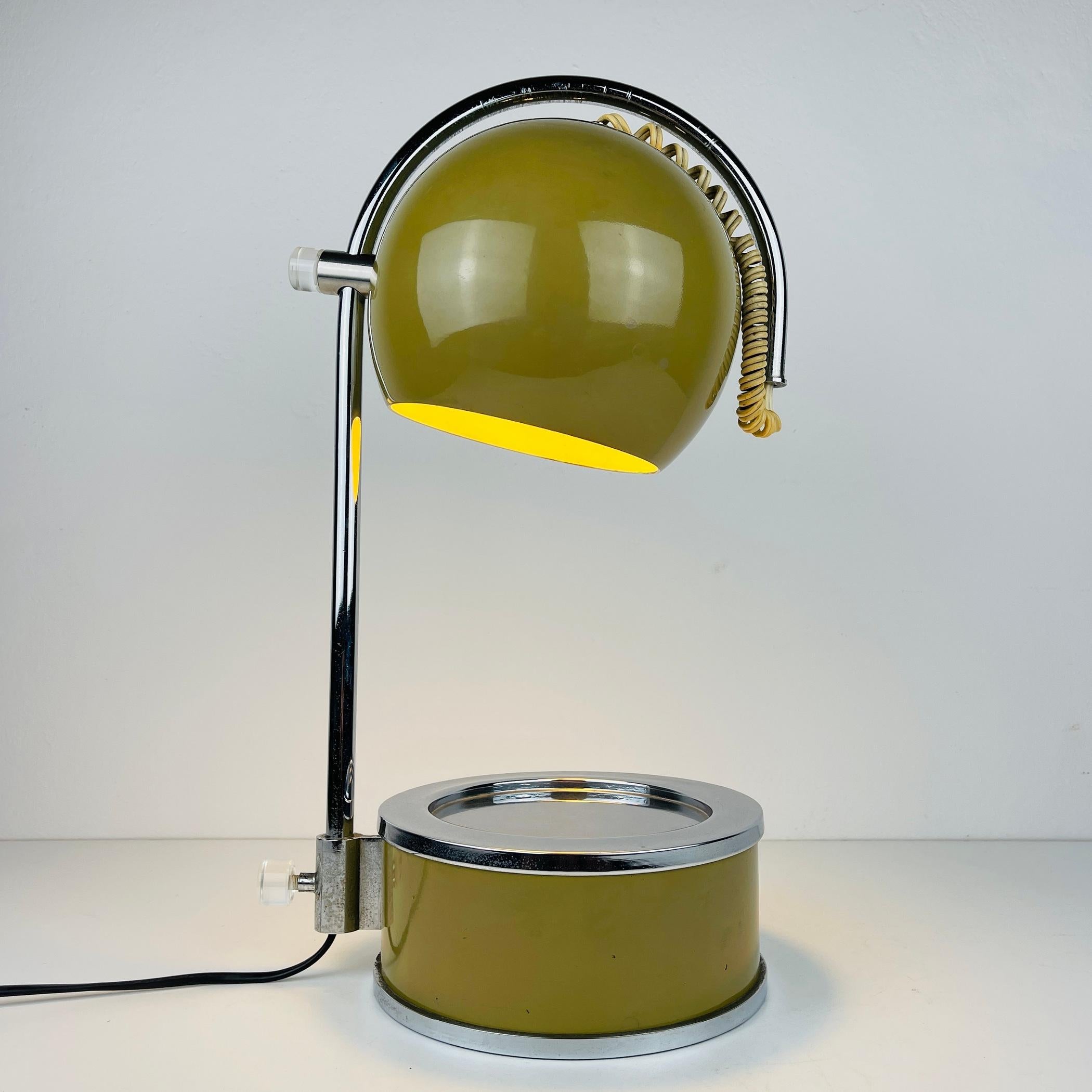 Step back in time to the swinging '60s with this stylish Italian vintage adjustable desk lamp. Crafted entirely from metal, this lamp exudes an authentic retro charm that's sure to make a statement in your space. The lamp's fully rotatable design