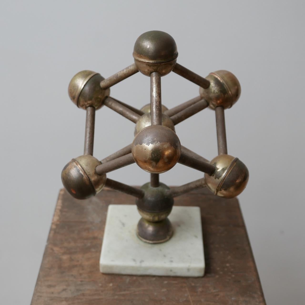 A vintage model in brass and marble of the 'Atomium' building in Brussels, Belgium.

A larger model than usual, perfect as a desk or shelf curio.

Belgium, circa 1960s.

Dimensions: 31 H x 26 W x 26 D in cm.

 