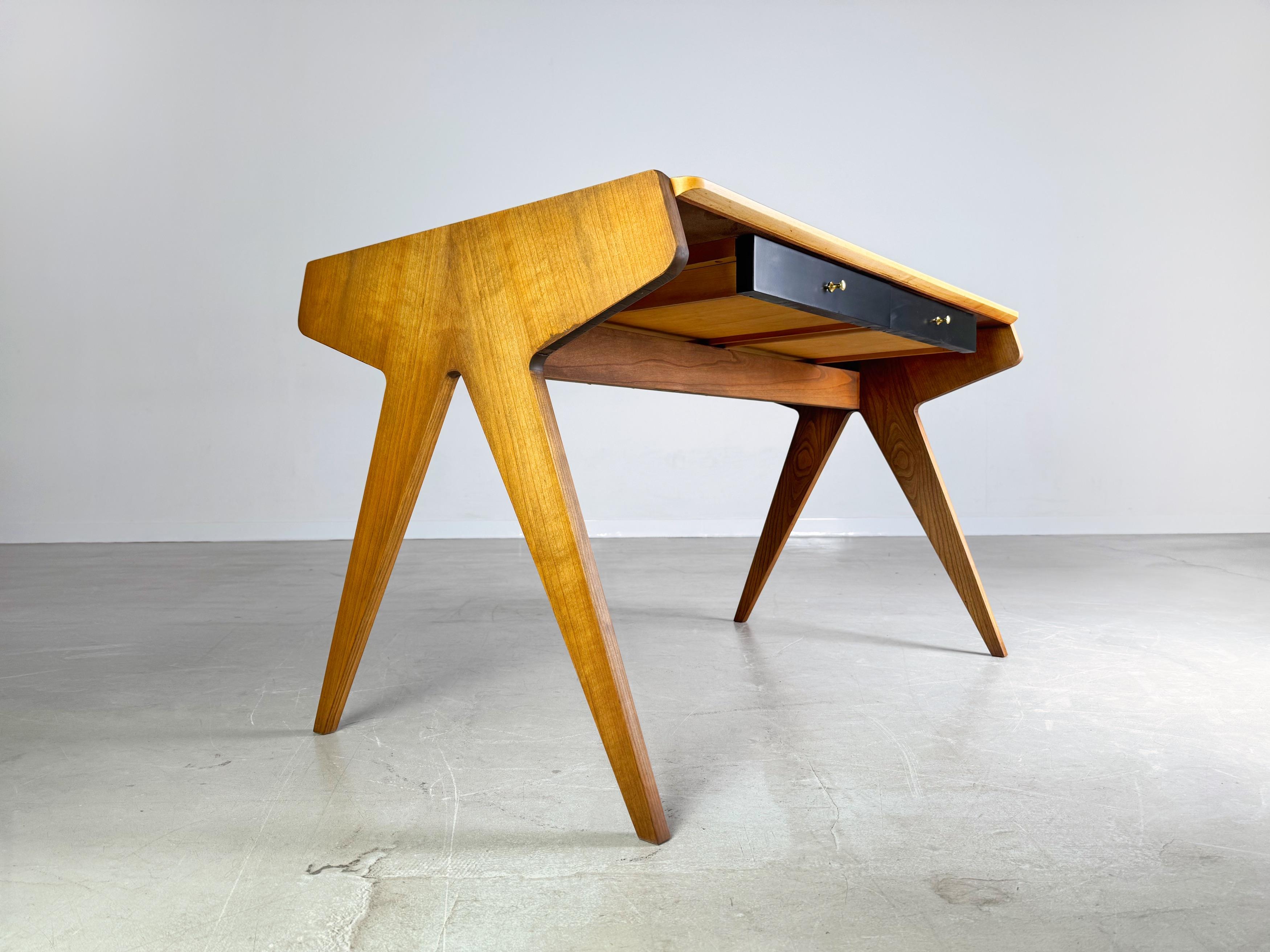 We are offering a beautiful scissor desk by WK Möbel from the 1950s for sale. The design is by Helmut Magg and is characterized by the shape of the table legs in “scissor look”. The desk has two drawers underneath and a large storage area behind the
