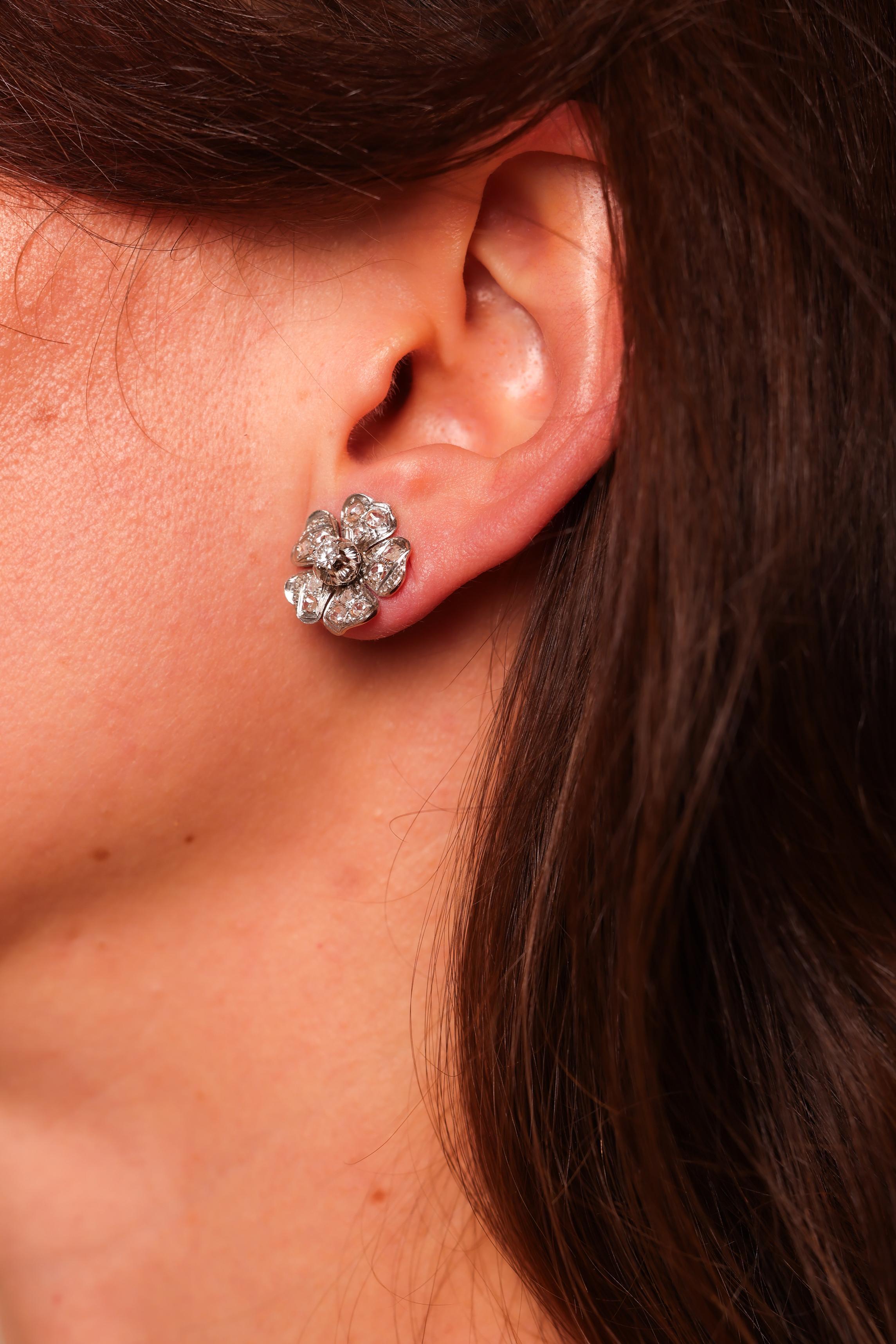 Center Stone: 26 Diamonds
Cut: Round Brilliant and Rose Cut
Weight: Approximately 1 Carats
Color: I-J
Clarity: SI
Metal: 18K Yellow and White Gold
Era: Mid-Century
Circa: 1960s
Size: 5/8 inches diameter
Gram weight: 5.54


These lovely mid-century