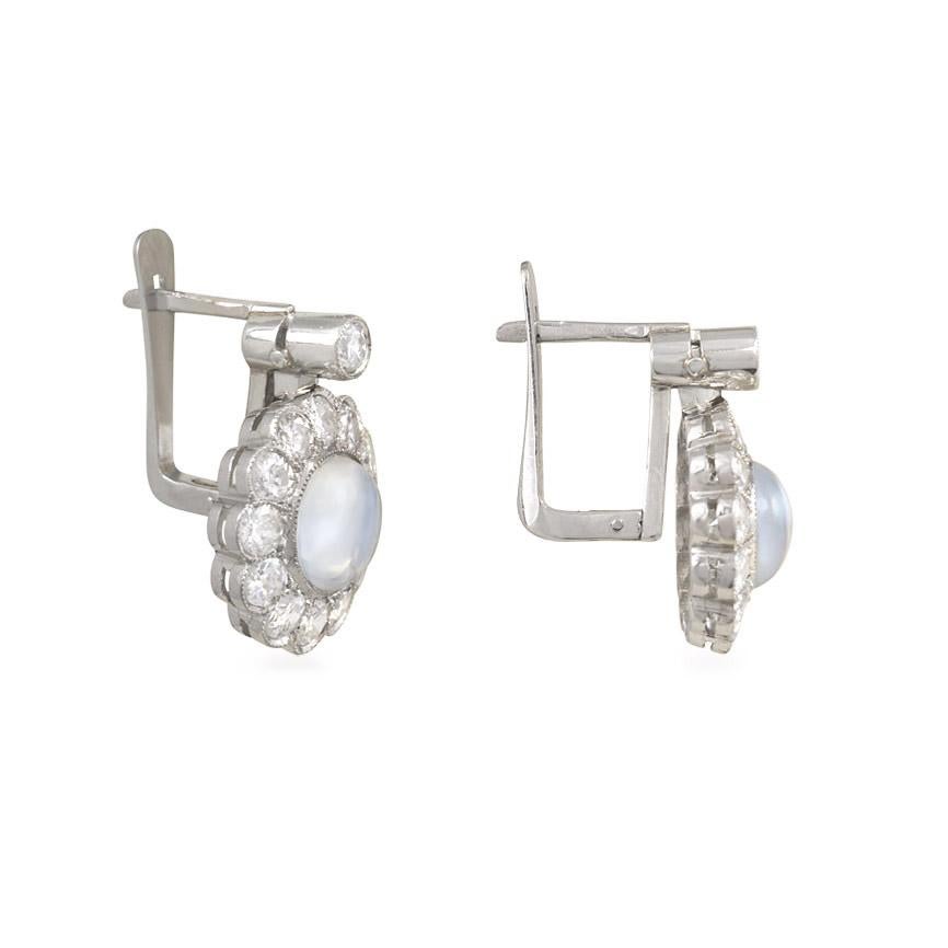A pair of mid-century round brilliant cut diamond and moonstone earrings of cluster drop design, in 18k white gold.  Portugal.  Atw 1.36 ct. diamonds.  A lovely option for a bride on her special day!

Moonstone is part of the feldspar group of