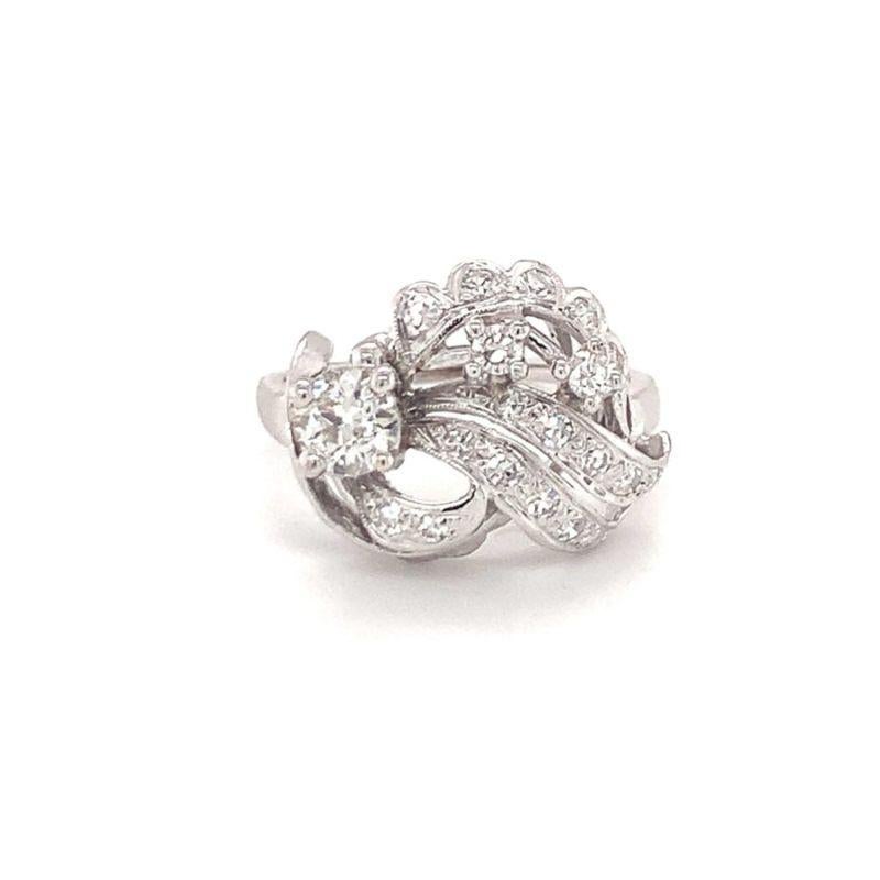 One mid-century diamond cluster ring in 14K white gold featuring old European cut, single cut and round brilliant cut diamonds totaling 1 ct. with one old Euro weighing 0.55 ct., J-K color and SI-2 clarity.

Dazzling, radiant, wavy.

Additional