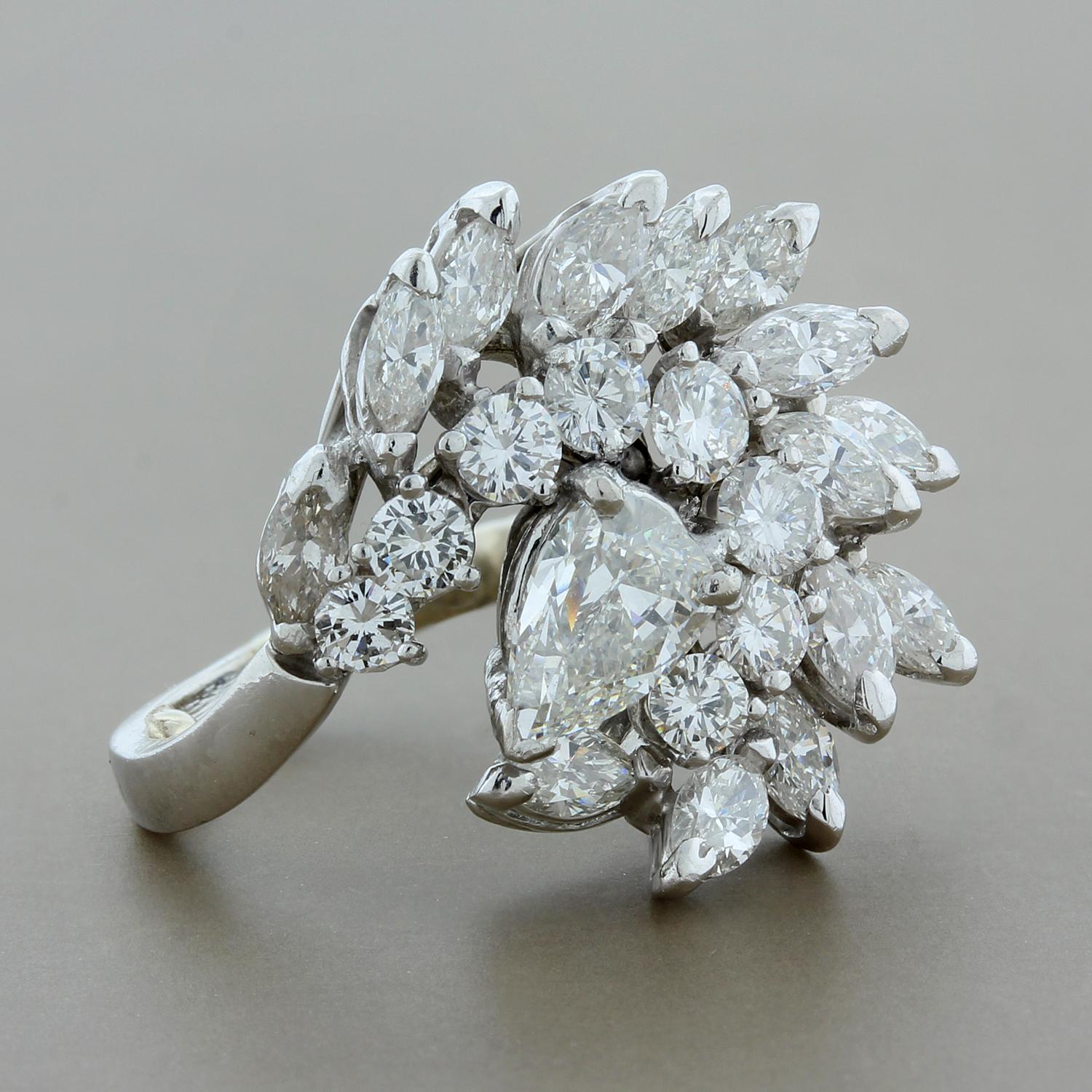 This extravagant estate ring features approximately 3.00 carats of pear, marquise and round cut diamonds set in platinum. The diamonds are organized in a swirling cluster arrangement giving the piece exceptional life and brilliance.  

Ring size 1.25