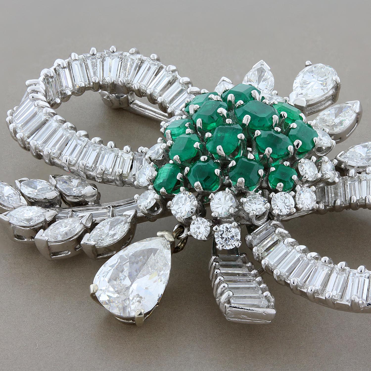 An expertly crafted brooch from the mid 1900’s featuring a total of 7 carats of diamonds including a 1.90 carat pear shape diamond drop. In the center of the brooch are 2 carats of fine deep green emeralds giving the piece great color. Set in