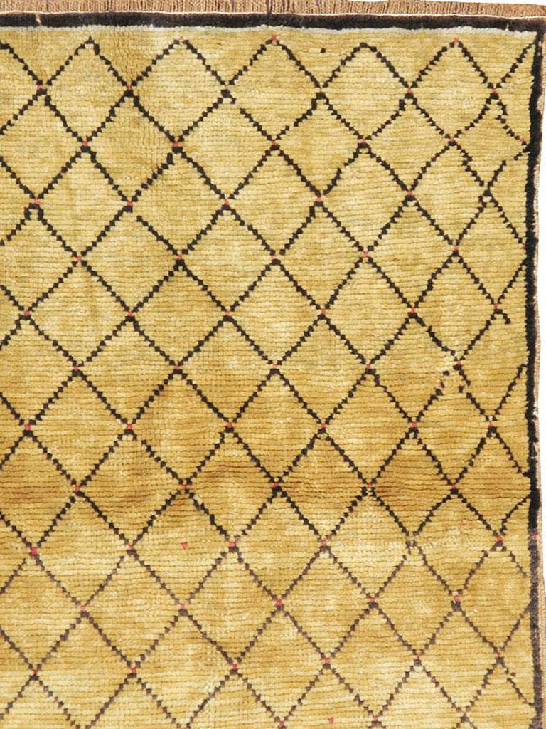 A modern Turkish Anatolian carpet from the 21st century with a Moroccan Berber design. Dark brown, black, and golden mustard are the only tones in this minimalistic diamond lattice pattern Anatolian scatter with a narrow string main border. Same