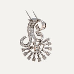 Broche de clip de 7,20 ct con diamantes, platino y oro, con motivos de volutas y ramitas
