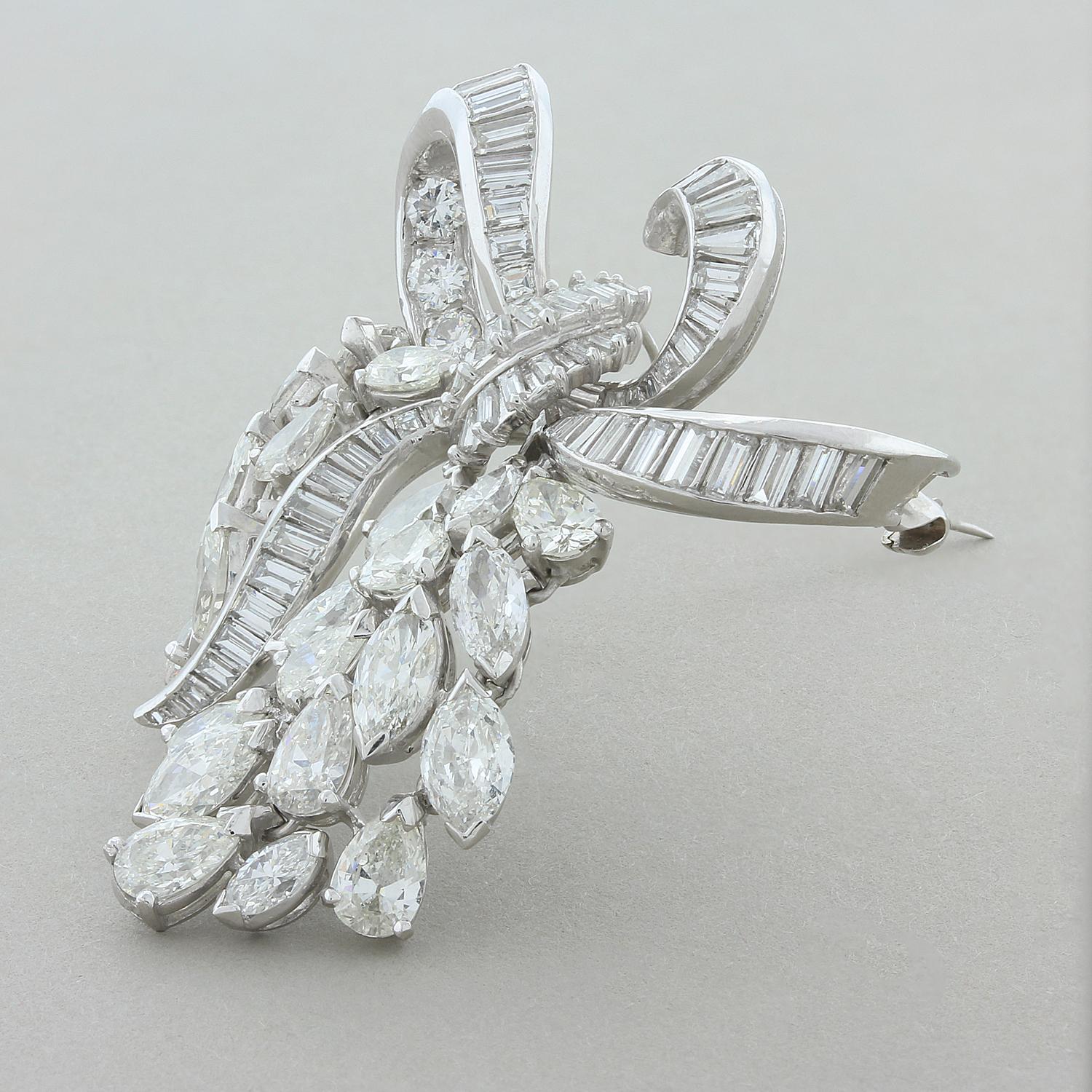 This expertly hand-crafted mid-century brooch, circa 1950, features large pear and marquise shape diamonds with baguette and round cut diamonds totaling 10.71 carats. The baguette and round cut diamonds create the bow while the marquise and pear cut