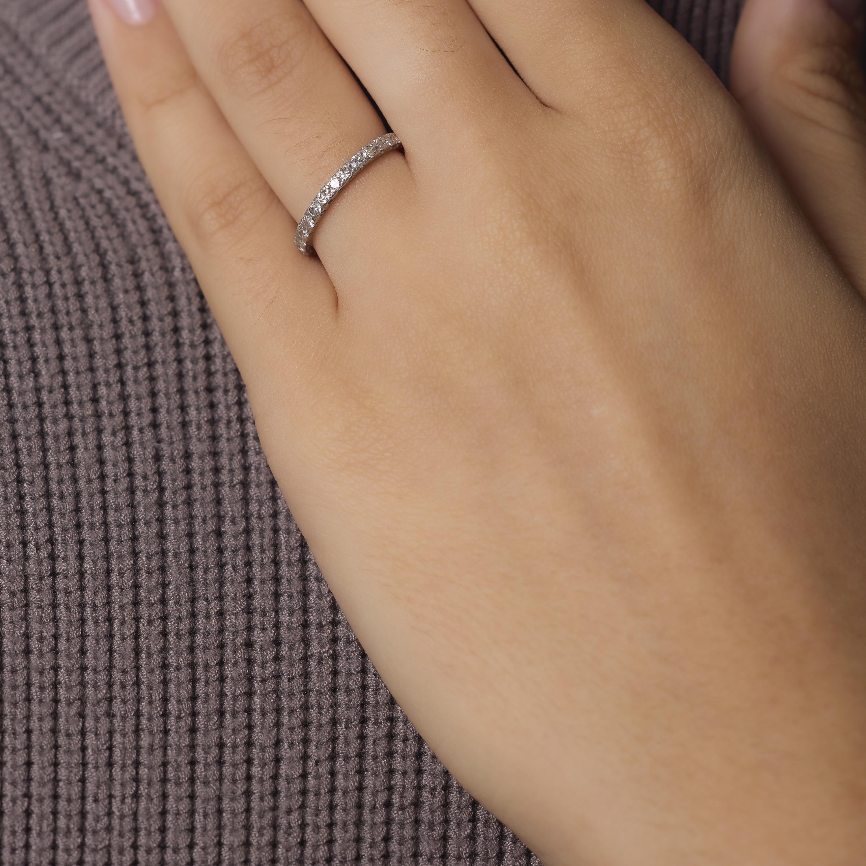 This Mid Century platinum eternity band shimmers with twenty-nine transitional cut diamonds encircling the finger in continuous brilliance. Crafted in the 1950s, its elegant profile and vintage sparkle make it a graceful symbol of lasting beauty and